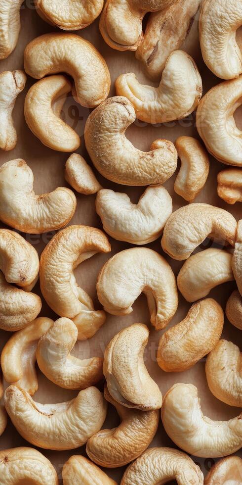 A close-up view of raw cashew nuts arranged on a brown background, showcasing their unique shape and texture, perfect for healthy snacks or nutritious recipes. photo