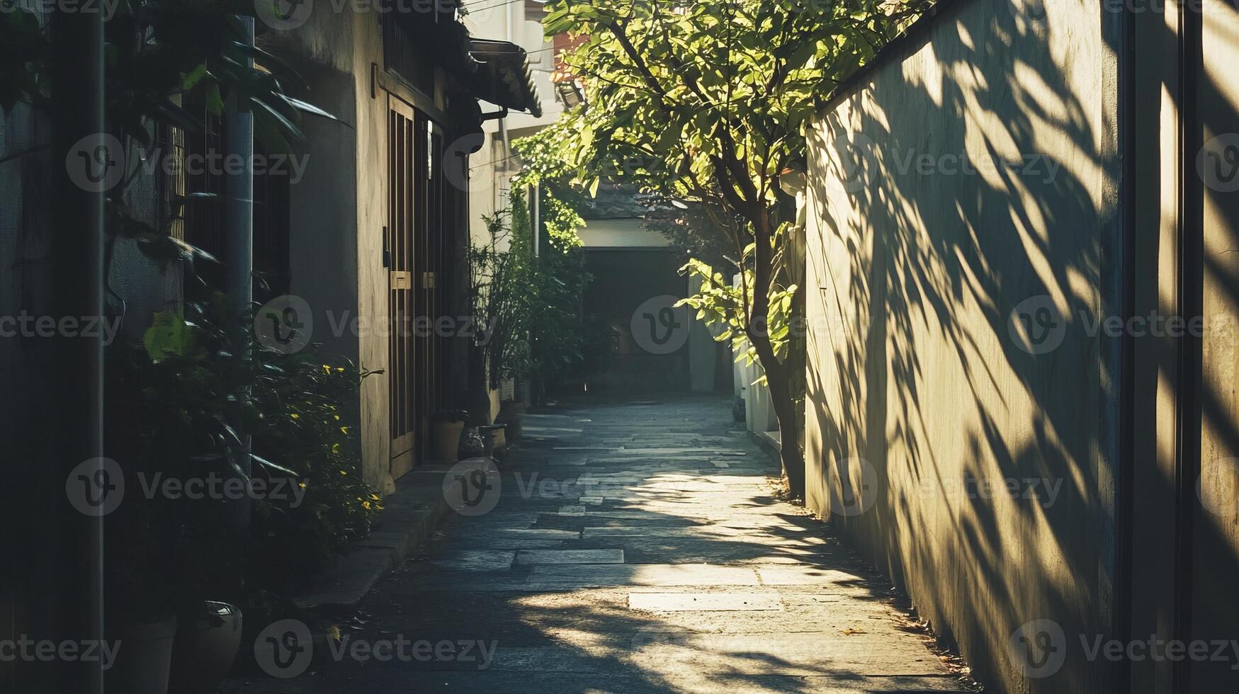 A peaceful alleyway bathed in sunlight, featuring lush greenery and rustic architecture, creating a tranquil urban escape. photo