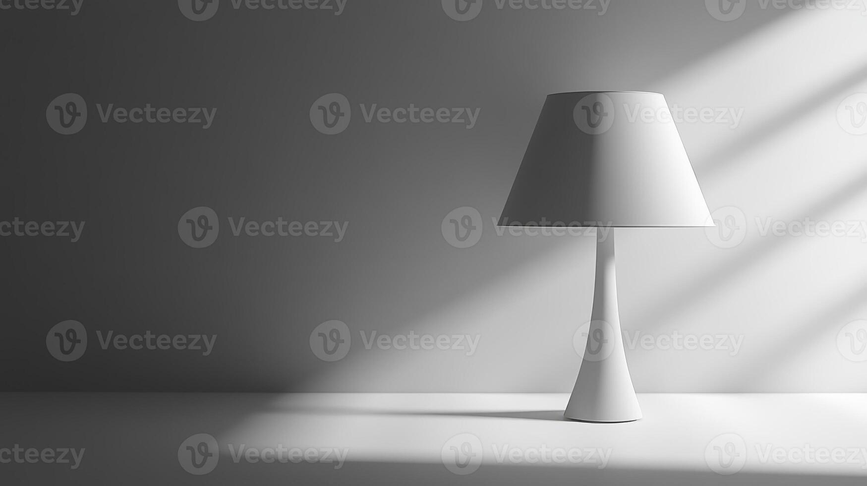 A lamp is sitting on a table in front of a wall. The lamp is white and has a shade photo