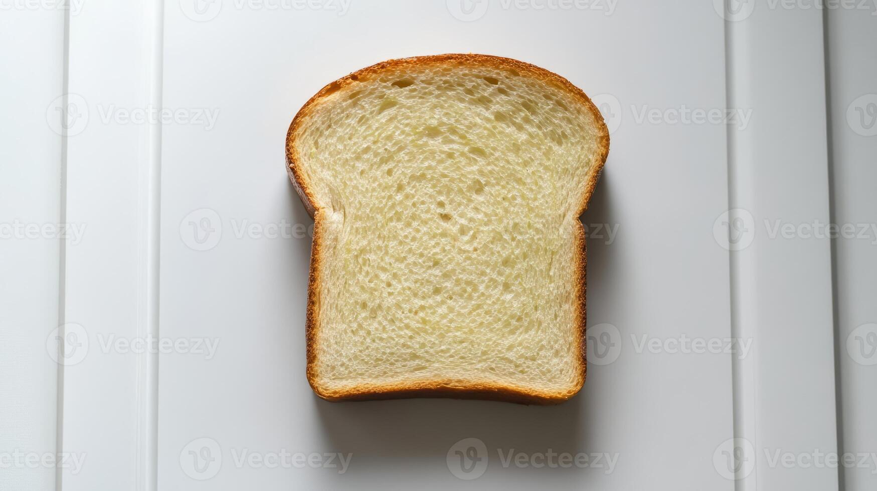 Slice of white bread is shown on a white background photo