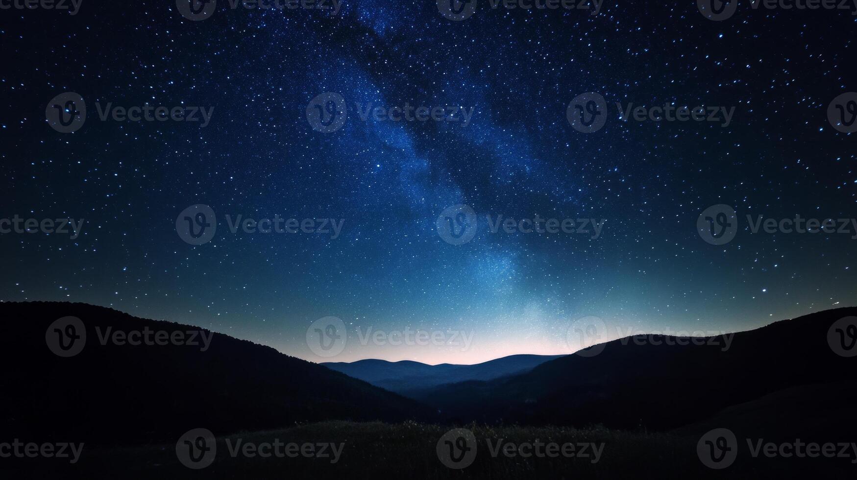 The milky way over mountains and hills at night photo