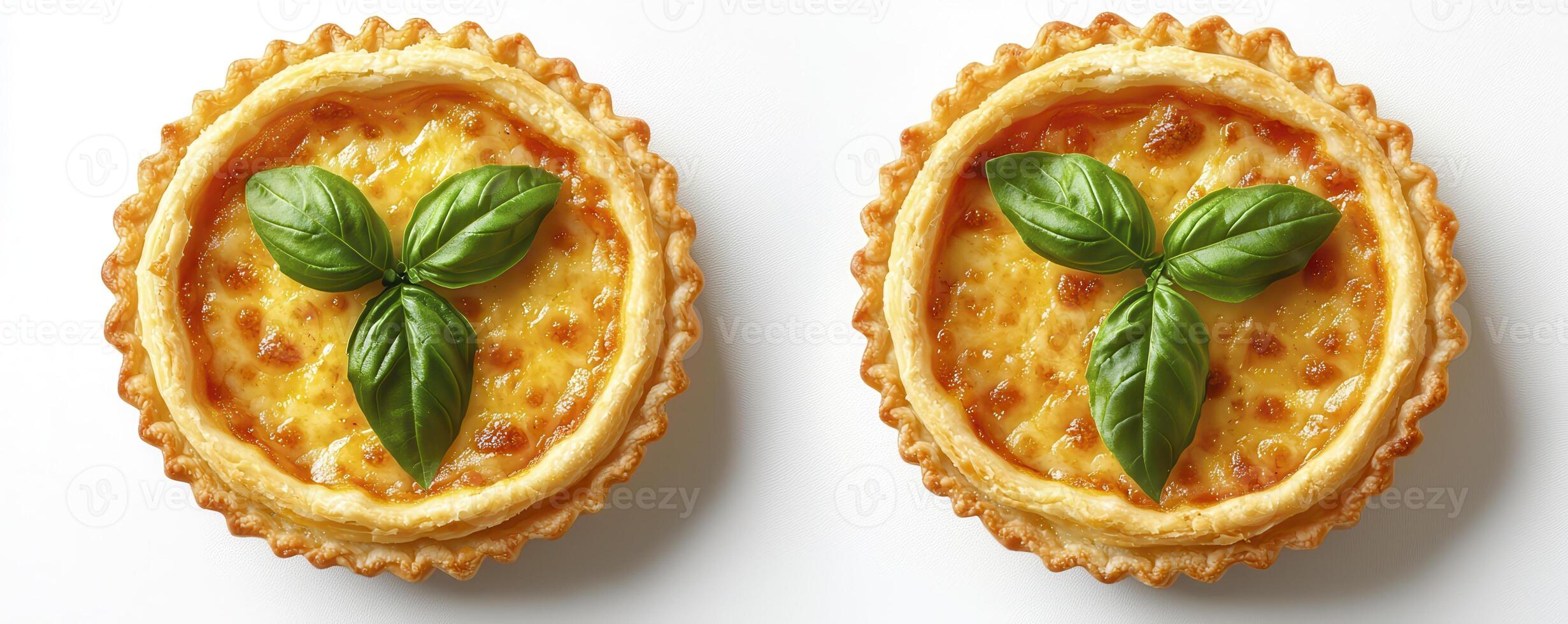 Delight in these two miniature savory custard tarts, adorned with vibrant green basil leaves, perfect for a sophisticated brunch or an elegant appetizer, each tart boasts a flaky golden crust and a photo