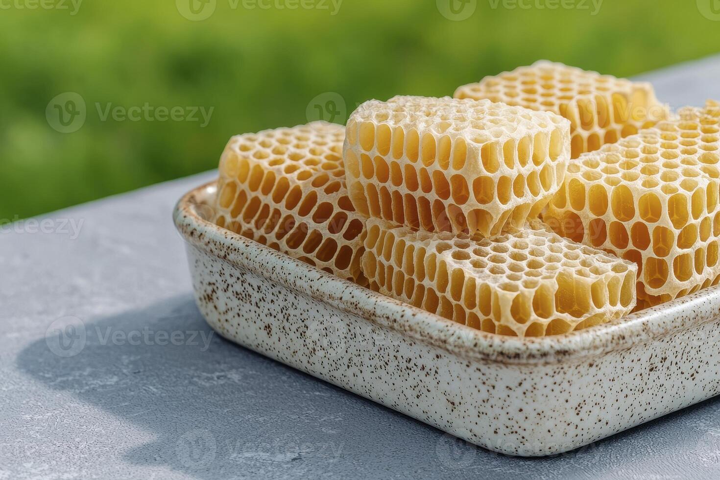 Discover the golden beauty of natural honeycomb, a raw and unprocessed delight from the hive Explore its intricate hexagonal cells, filled with pure, sweet honey, showcasing nature's perfect photo