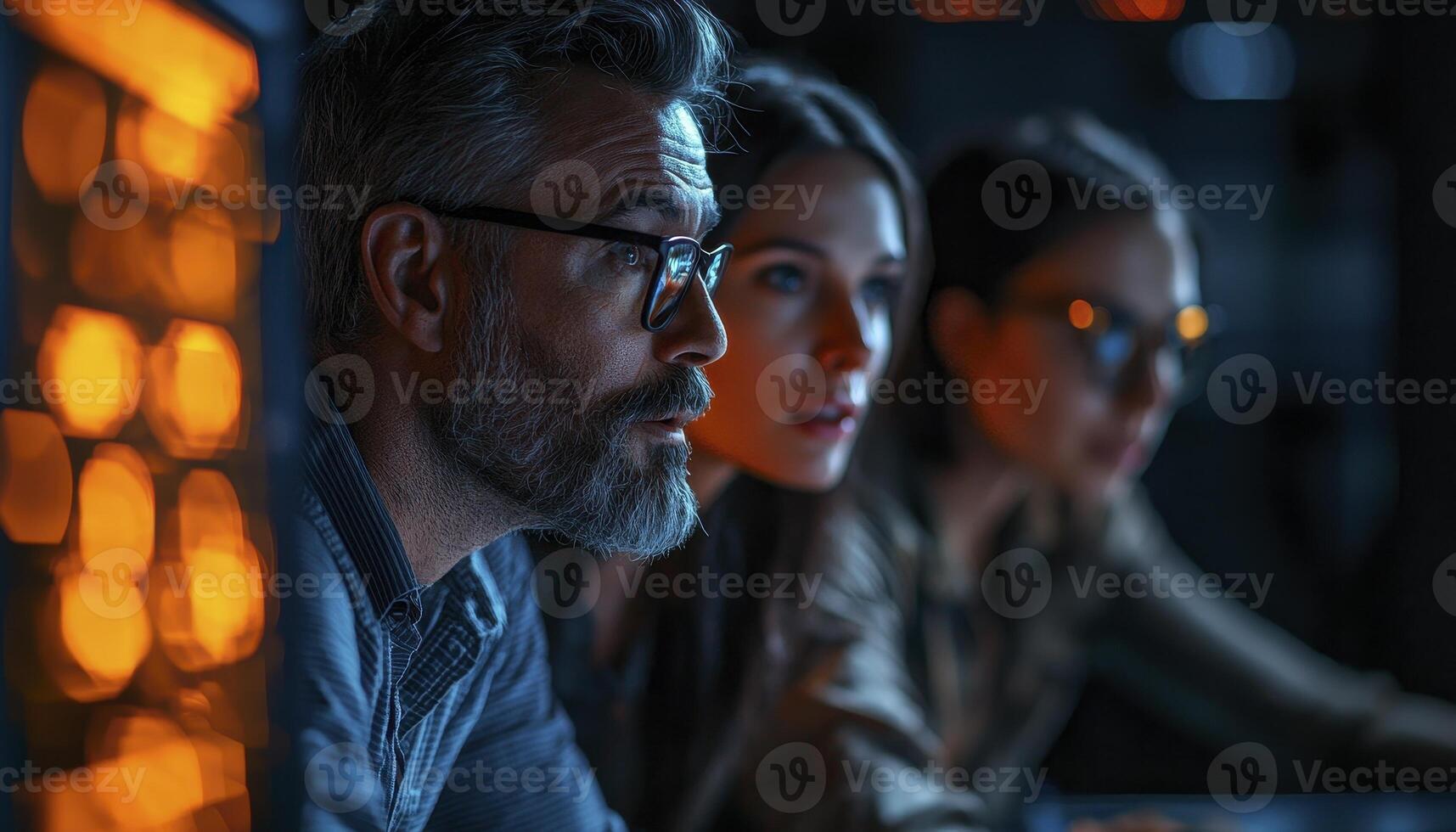 Focused teamwork depicted in this image, capturing collaboration among professionals in a modern workspace The scene highlights concentration and shared goals as team members engage with technology photo