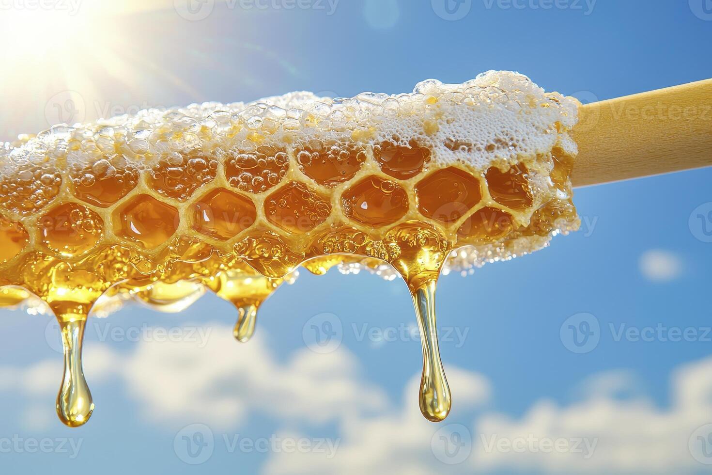 Golden honeycomb dripping with sweet honey against a bright blue sky, capturing the essence of nature's bounty and the deliciousness of pure, unfiltered goodness, evokes feelings of warmth photo