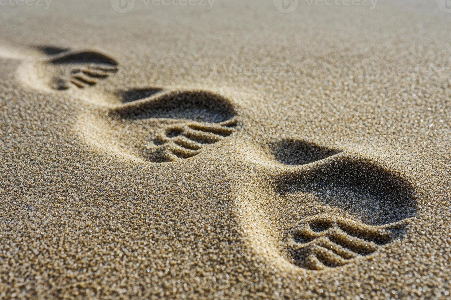 A tranquil scene unfolds, capturing the essence of nature's artistry Soft sand dunes, sculpted by the relentless caress of wind, stretch towards the horizon Footprints, like fleeting memories, mark a photo