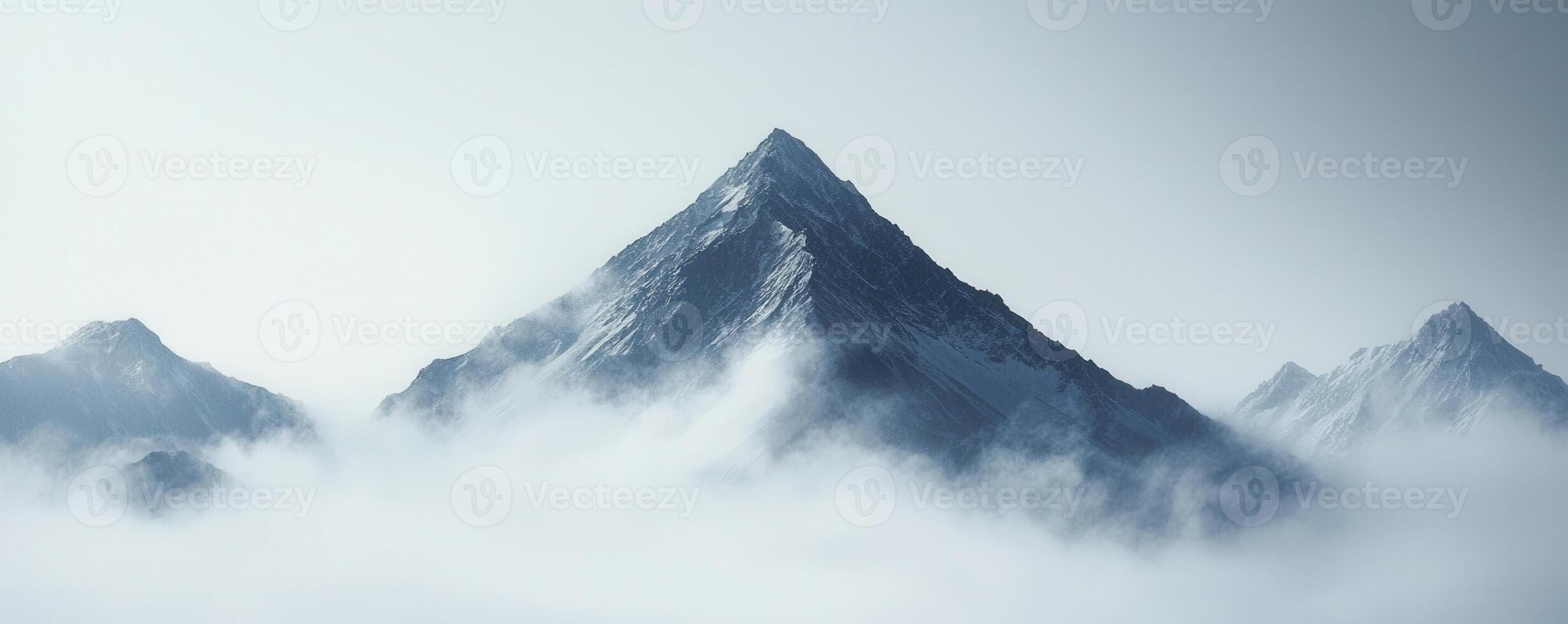 Above the world, a majestic mountain peak pierces through a swirling canvas of dense fog The scene evokes a sense of ethereal grandeur and serene isolation The jagged, snow-dusted summit rises as a photo