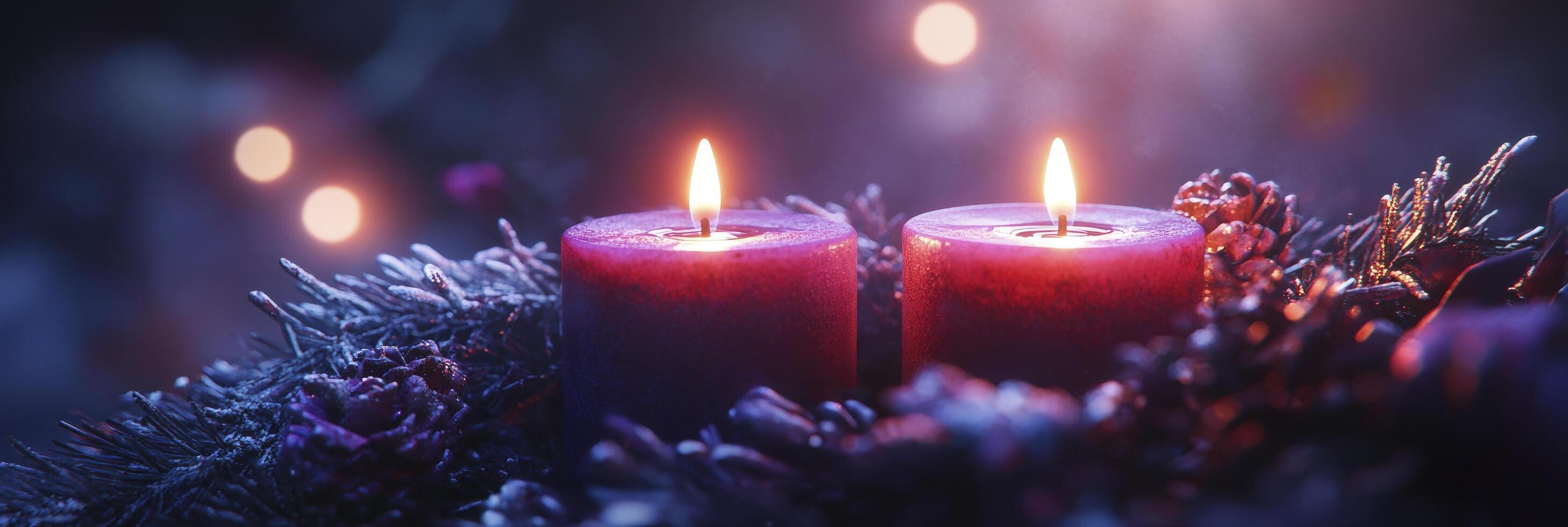 Two candles are lit in front of a wreath photo