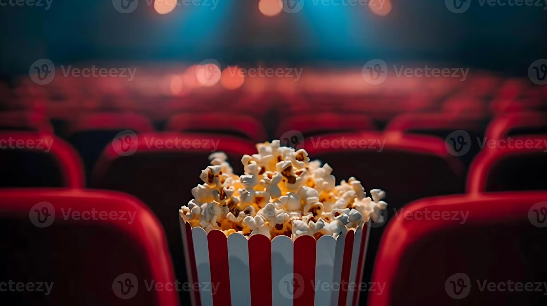 Popcorn in a red bucket on a red chair photo