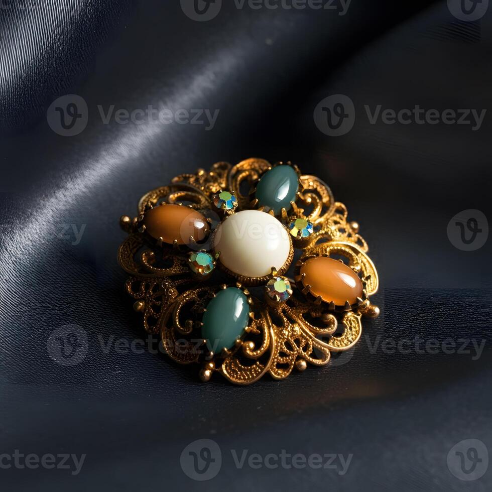 Vintage brooch with amber gemstone and blue cabochons on silky fabric luxury antique jewelry close up photo
