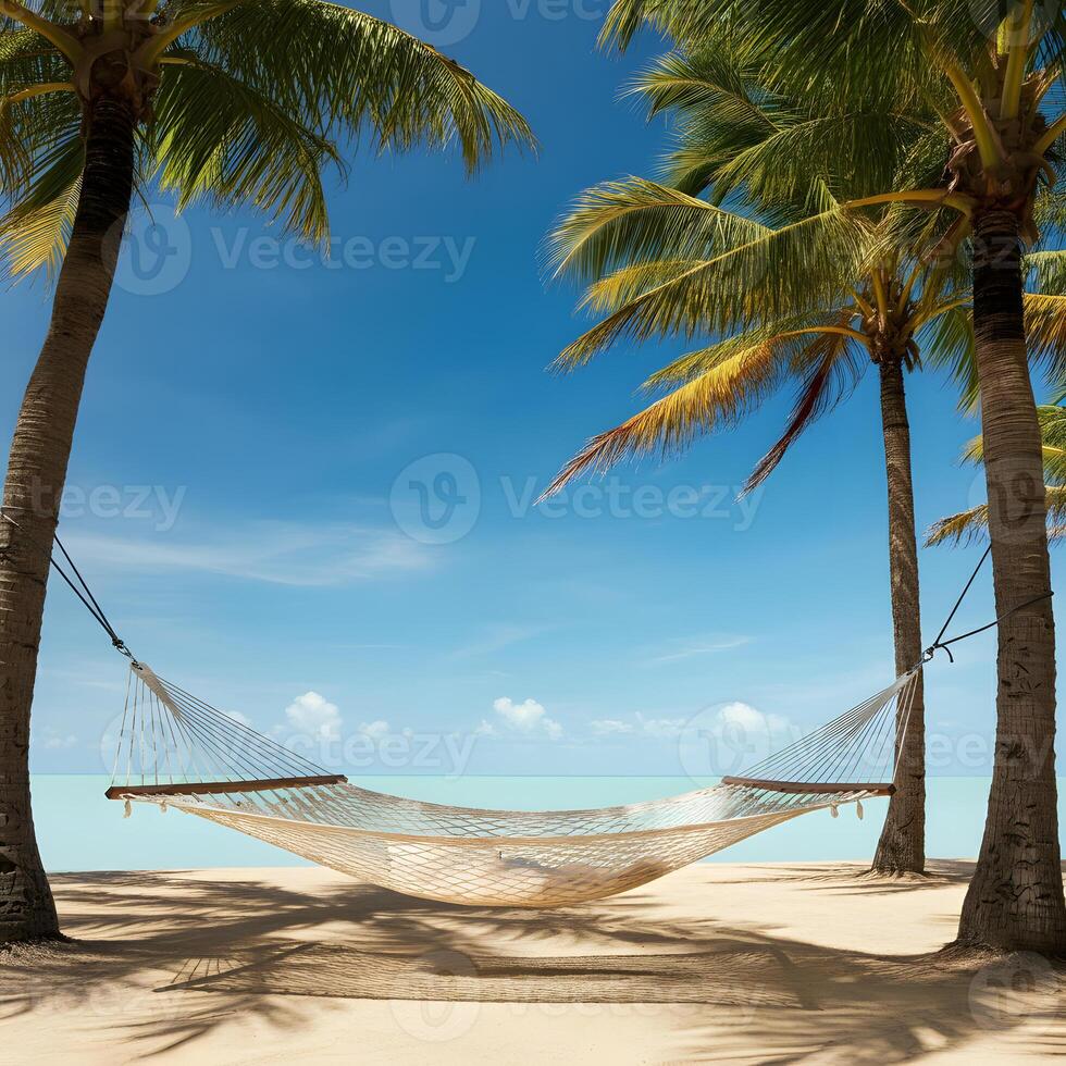 Empty woven hammock tied between two palm trees overlooking calm sea on a tropical sandy beach under soft cloudy sky photo