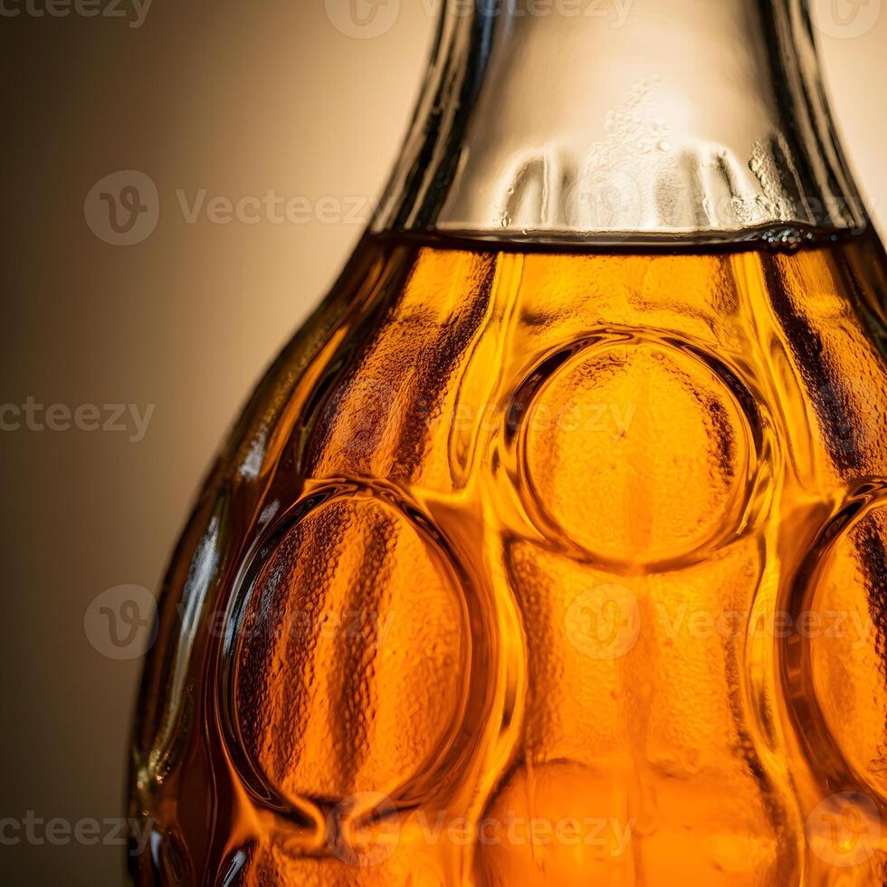 Close up of an amber glass bottle with condensation and warm backlight emphasizing texture and transparency photo