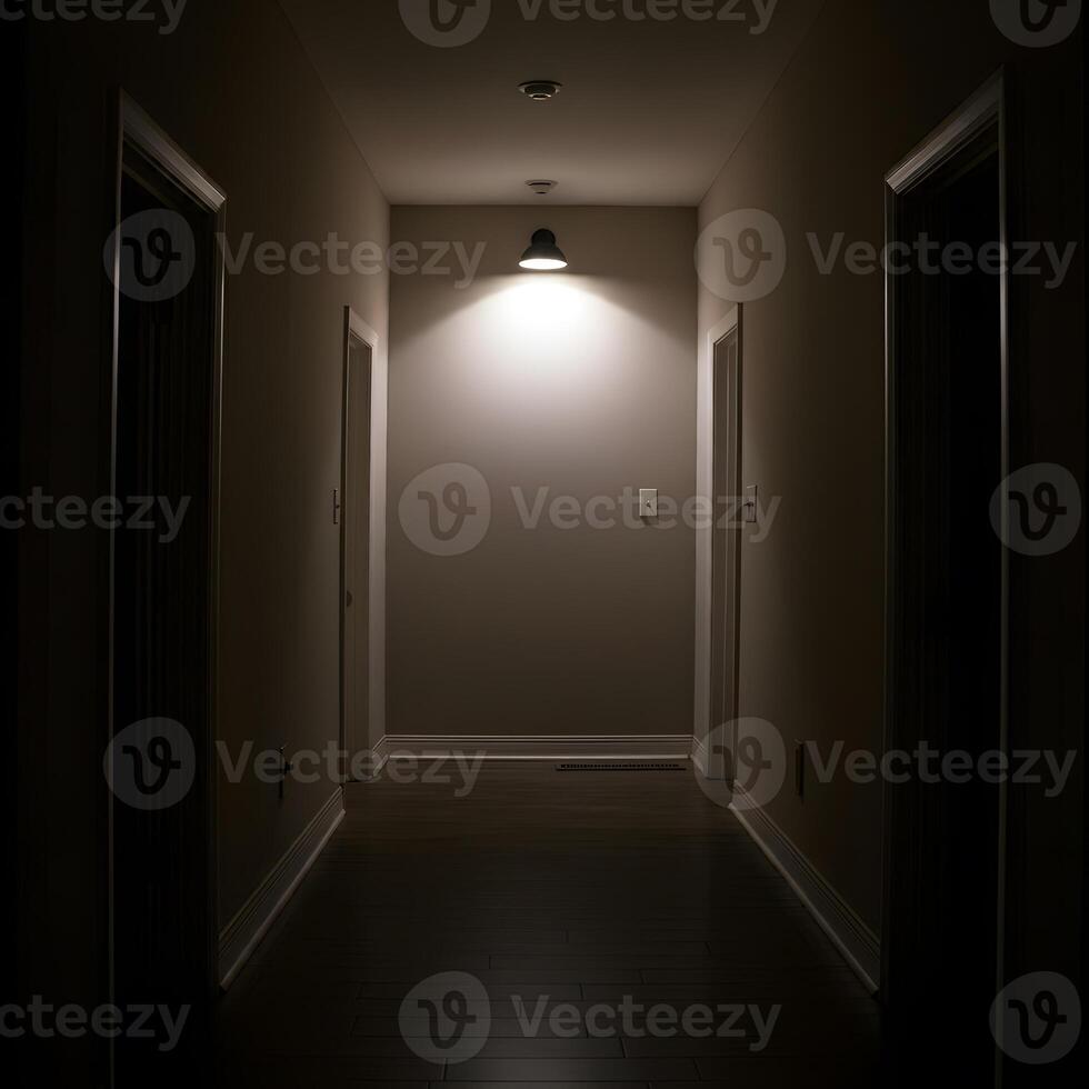 Dimly lit narrow hallway with single ceiling lamp casting moody shadows creating suspenseful atmosphere photo