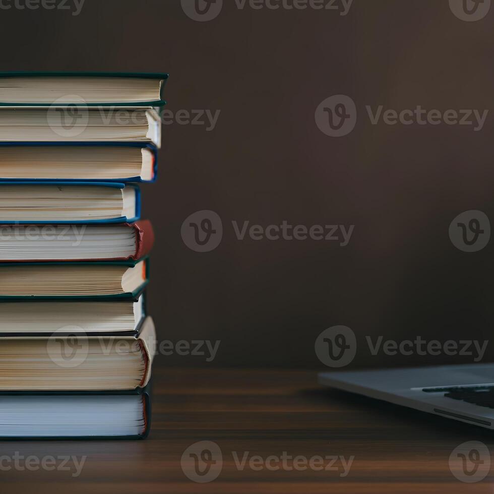 Stack of books and open laptop on wooden desk symbolizing knowledge education and learning workspace academic study research photo