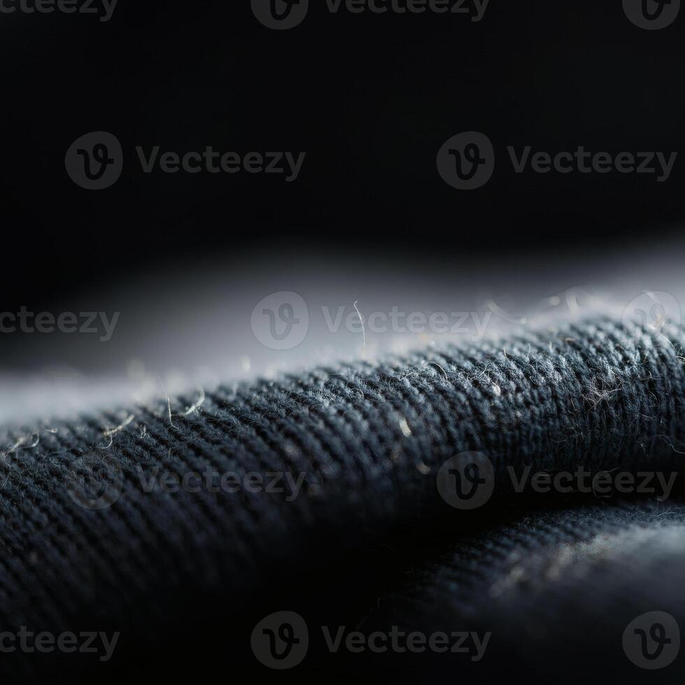 Close up of black fabric texture with visible lint and dust fibers clothing material macro textile surface details photo