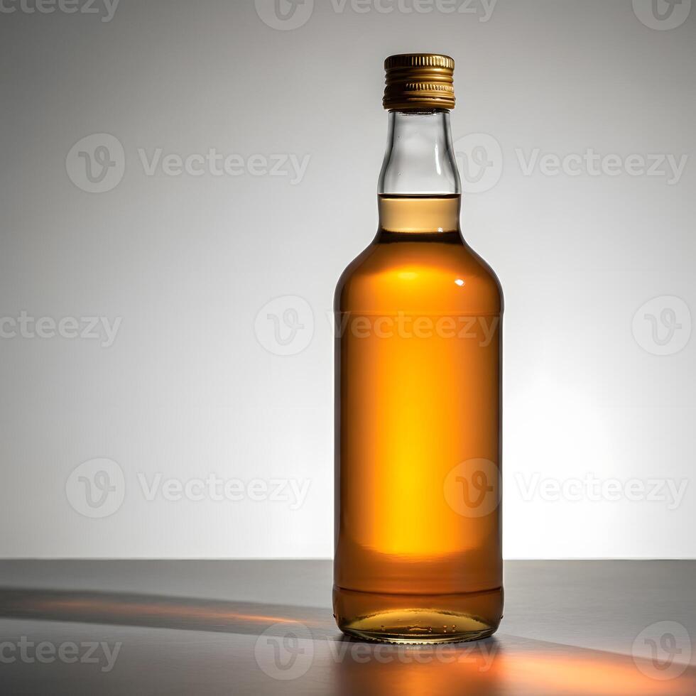 Elegant whiskey bottle with golden amber liquid illuminated under soft light on minimalist neutral background photo