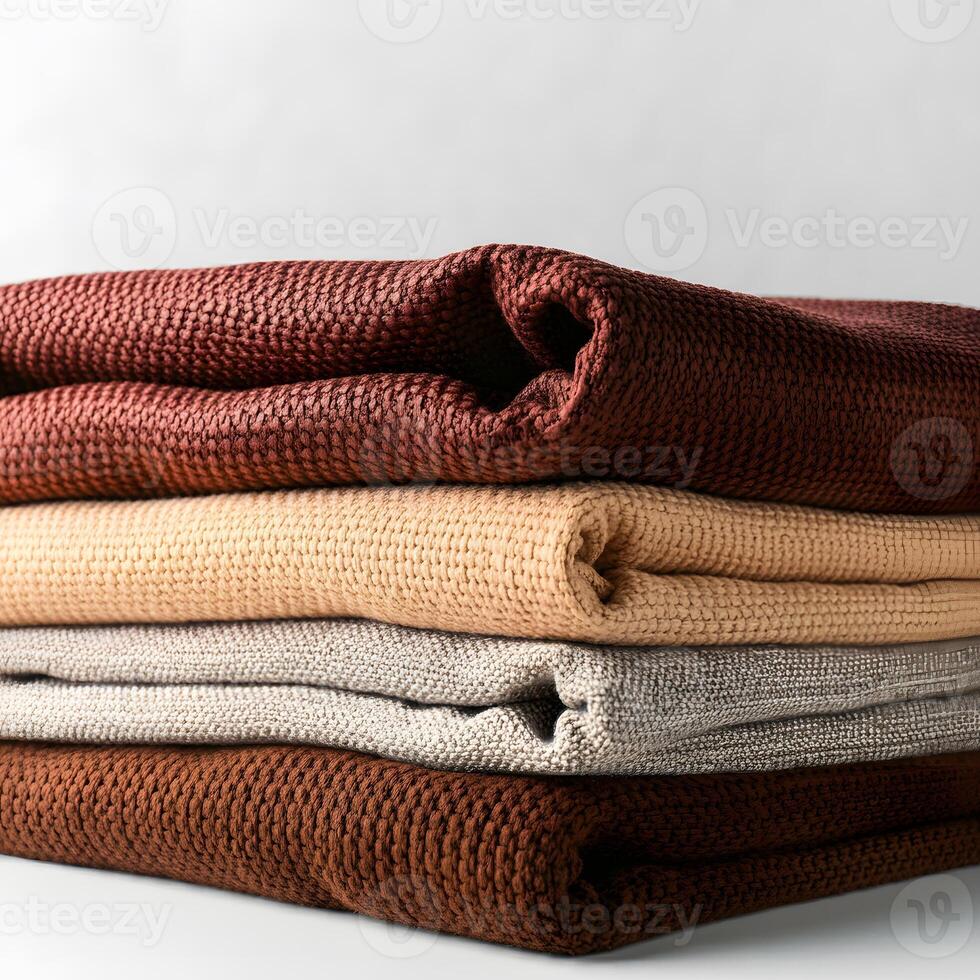 Folded cotton linen fabric in neutral earthy tones stacked on the white background texture textile design home decor concept photo
