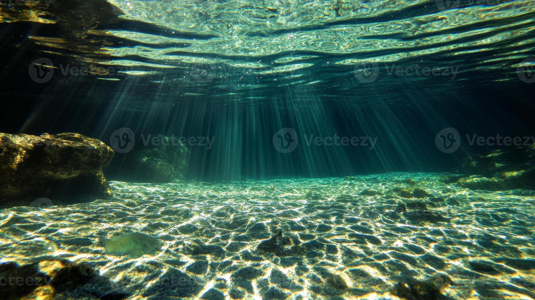 Sunlight filtering through clear water in a serene underwater ocean scene photo