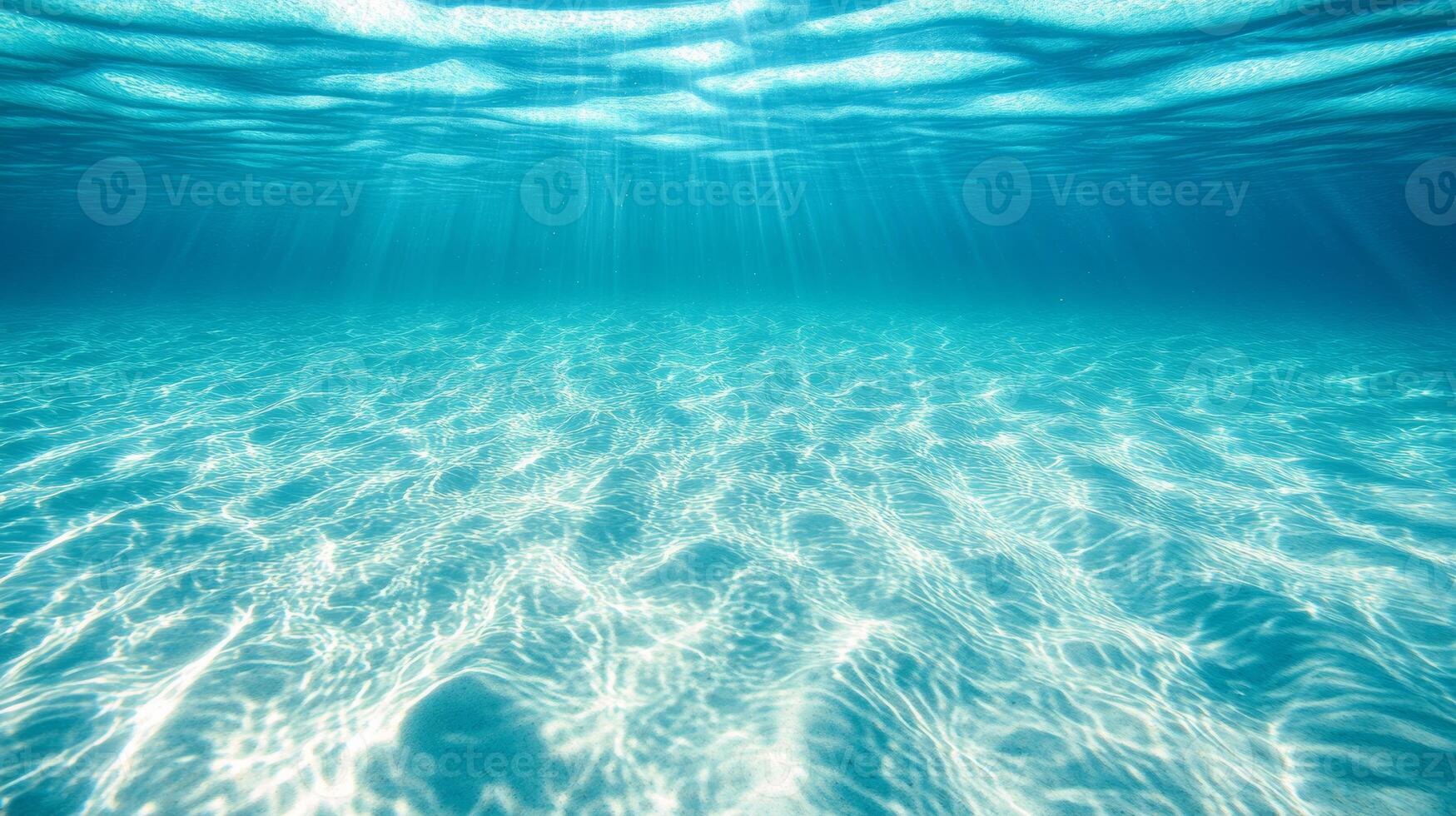 Sunlit underwater scene with rippling sand and clear blue water photo