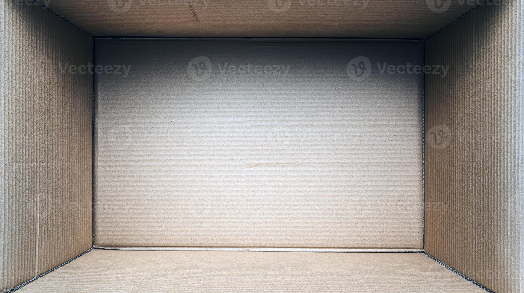 Empty corrugated cardboard box with open flaps and brown texture photo