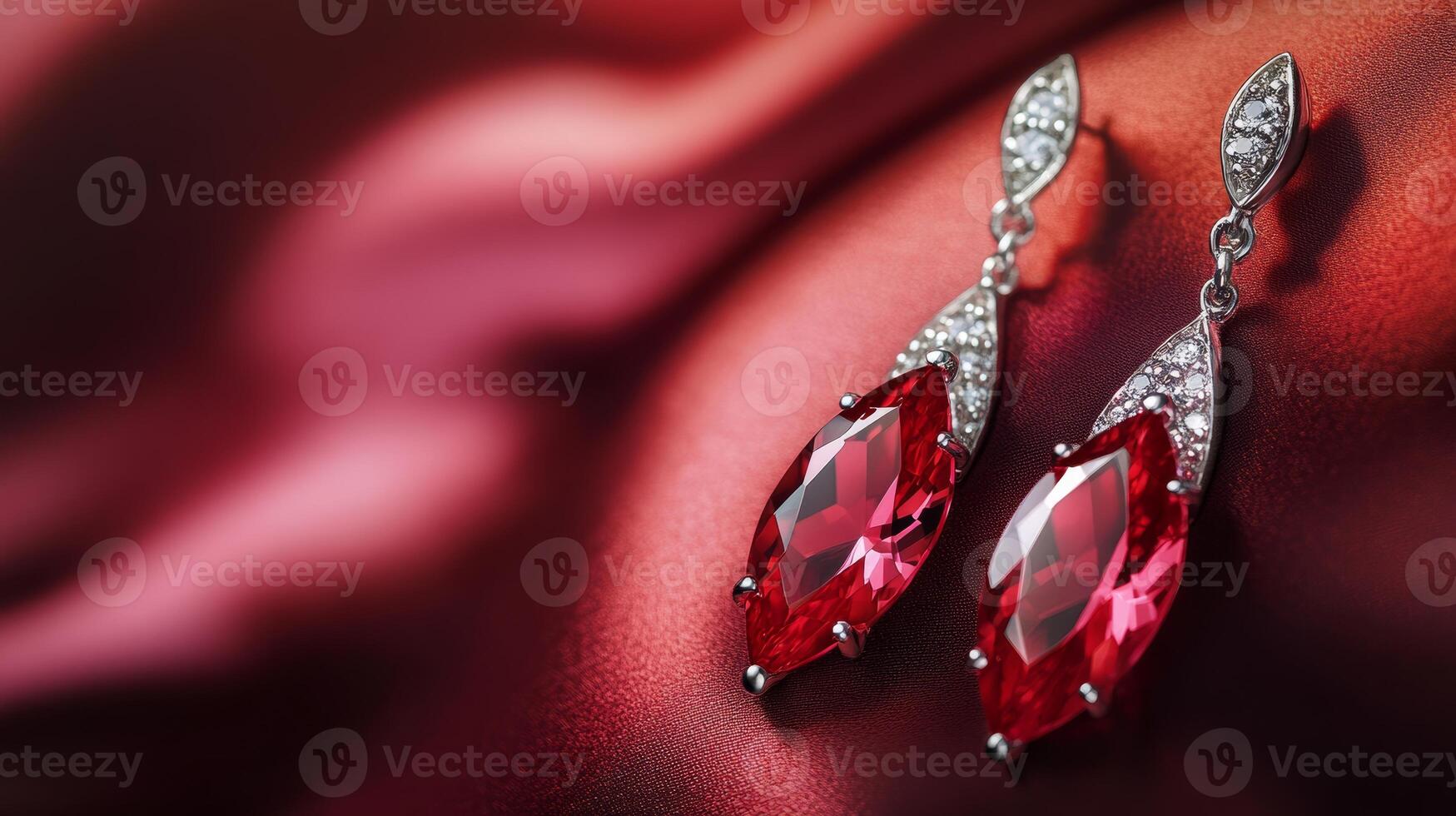 Sparkling red gemstone earrings on luxurious red satin background photo