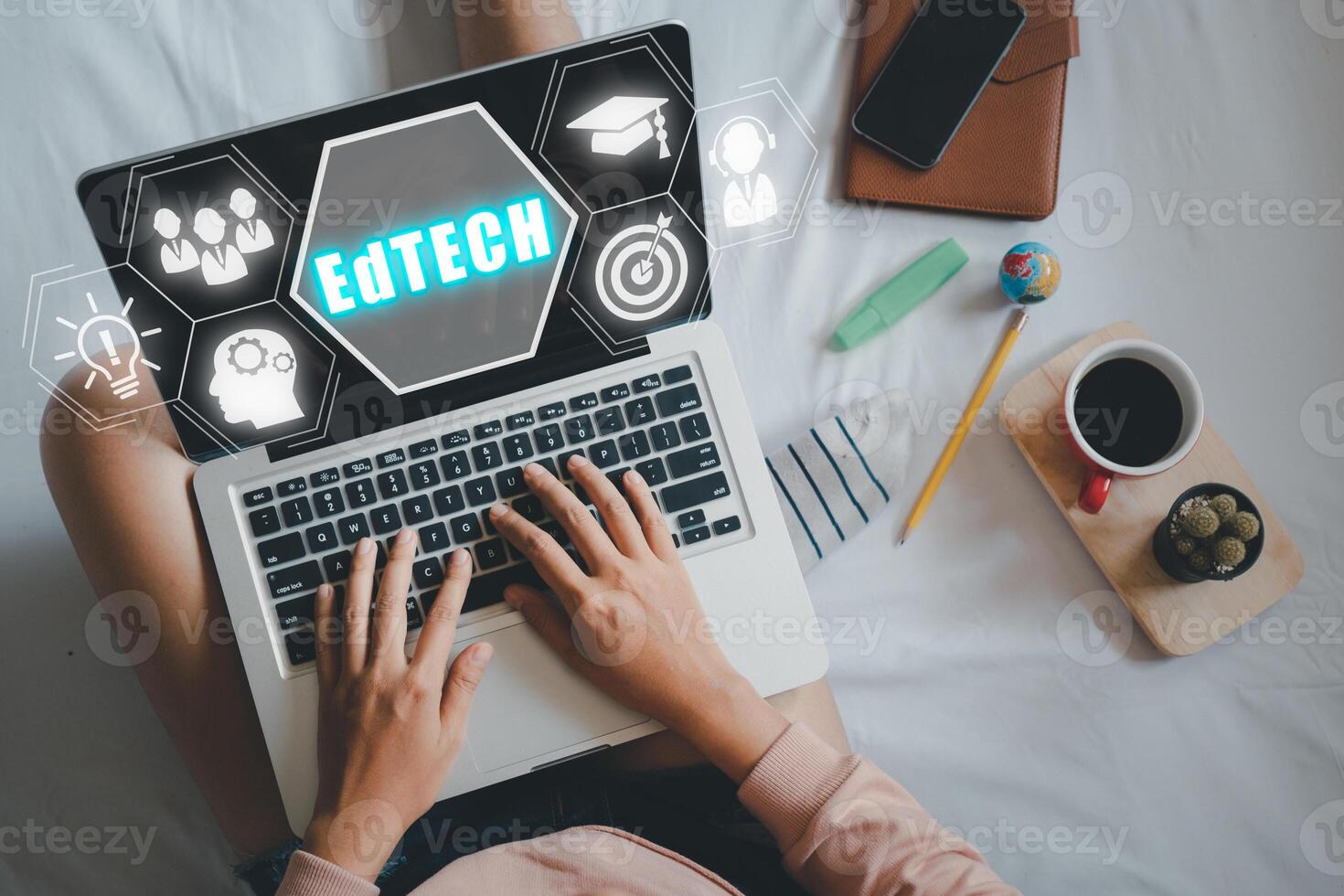 EdTech Education technology distance learning online concept, Person using laptop computer with Edtech icon on VR screen. Top view flat lay. photo