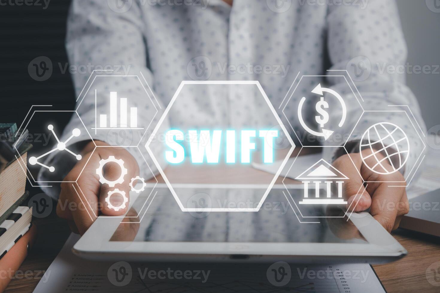 SWIFT, Society for Worldwide Interbank Financial Telecommunications, Business person using tablet with VR screen swift icon on office desk, Financial Banking regulation concept. photo