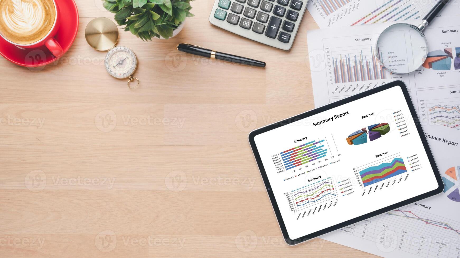 Tablet with charts and reports on office desk workplace. Top view photo