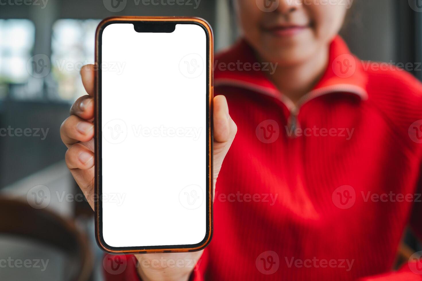 Close-up of a woman displaying a smartphone with a blank screen, ideal for showcasing apps or digital content. photo