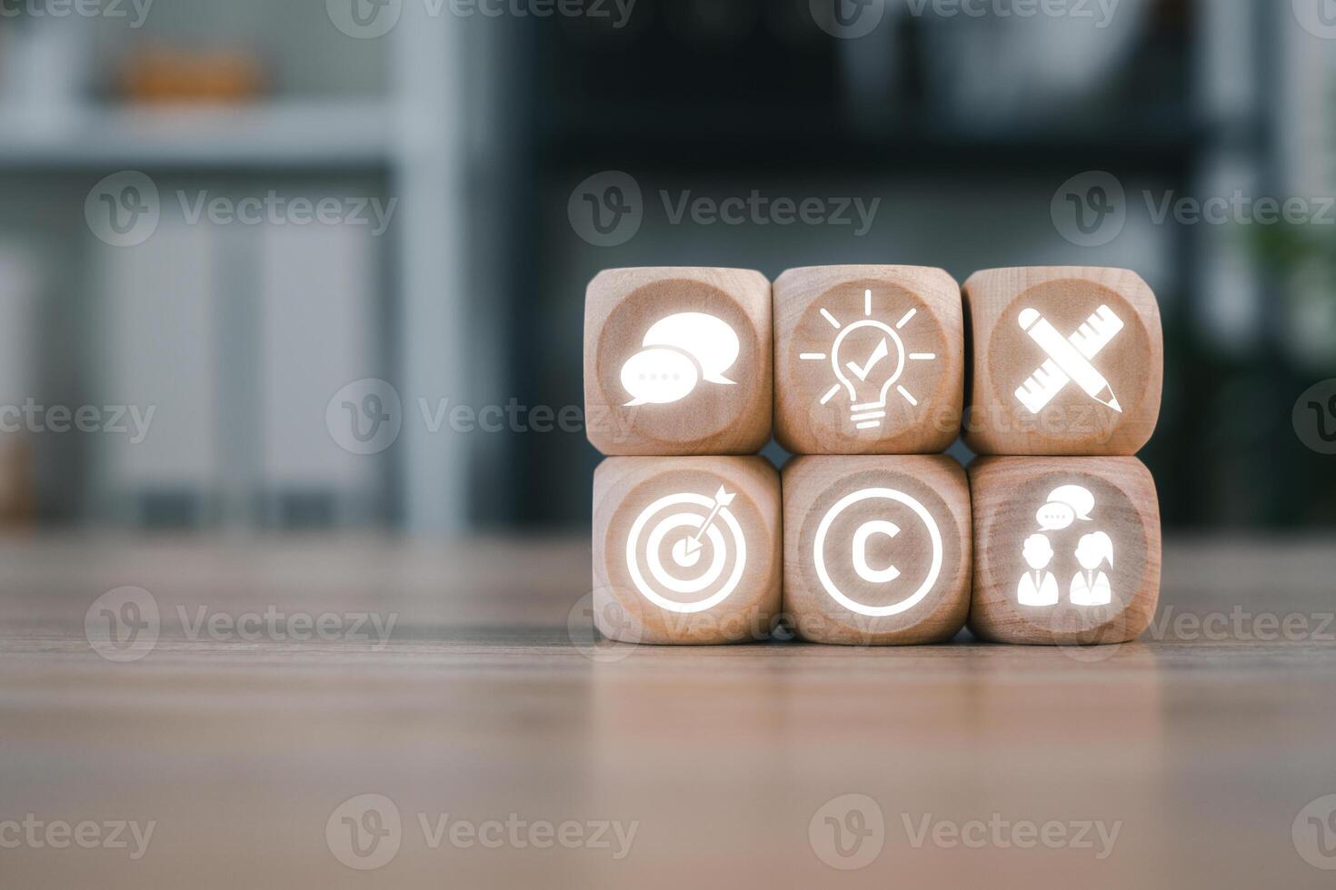Wooden blocks with corporate icons representing business identity, branding, and strategy in a modern office setting. photo