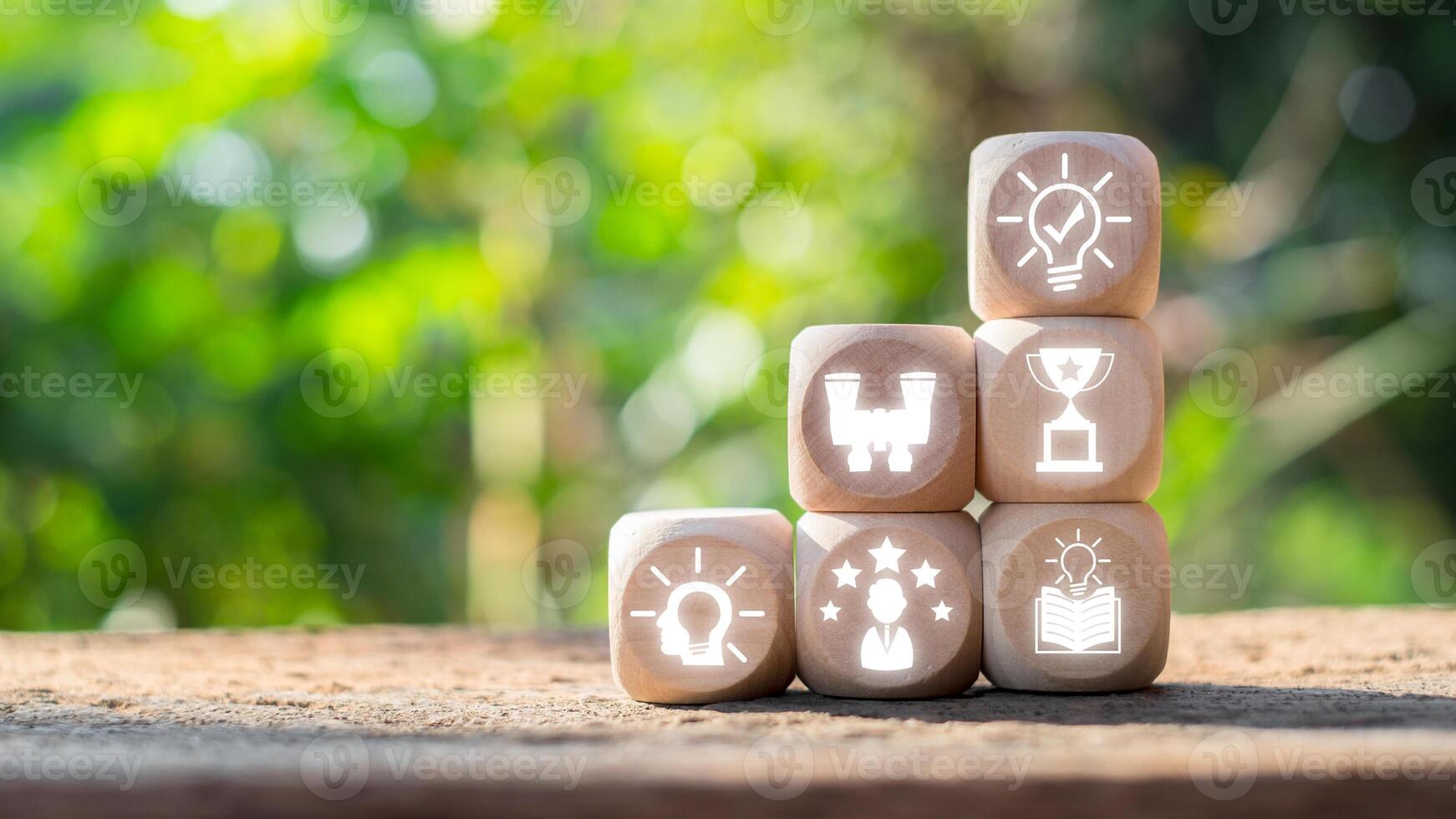 Wooden blocks with icons symbolizing success and achievement, set against a natural background, inspire motivation and results. photo