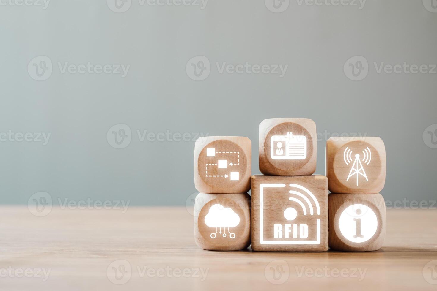 Wooden blocks with RFID icons representing data, identification, and wireless technology on a neutral background. photo