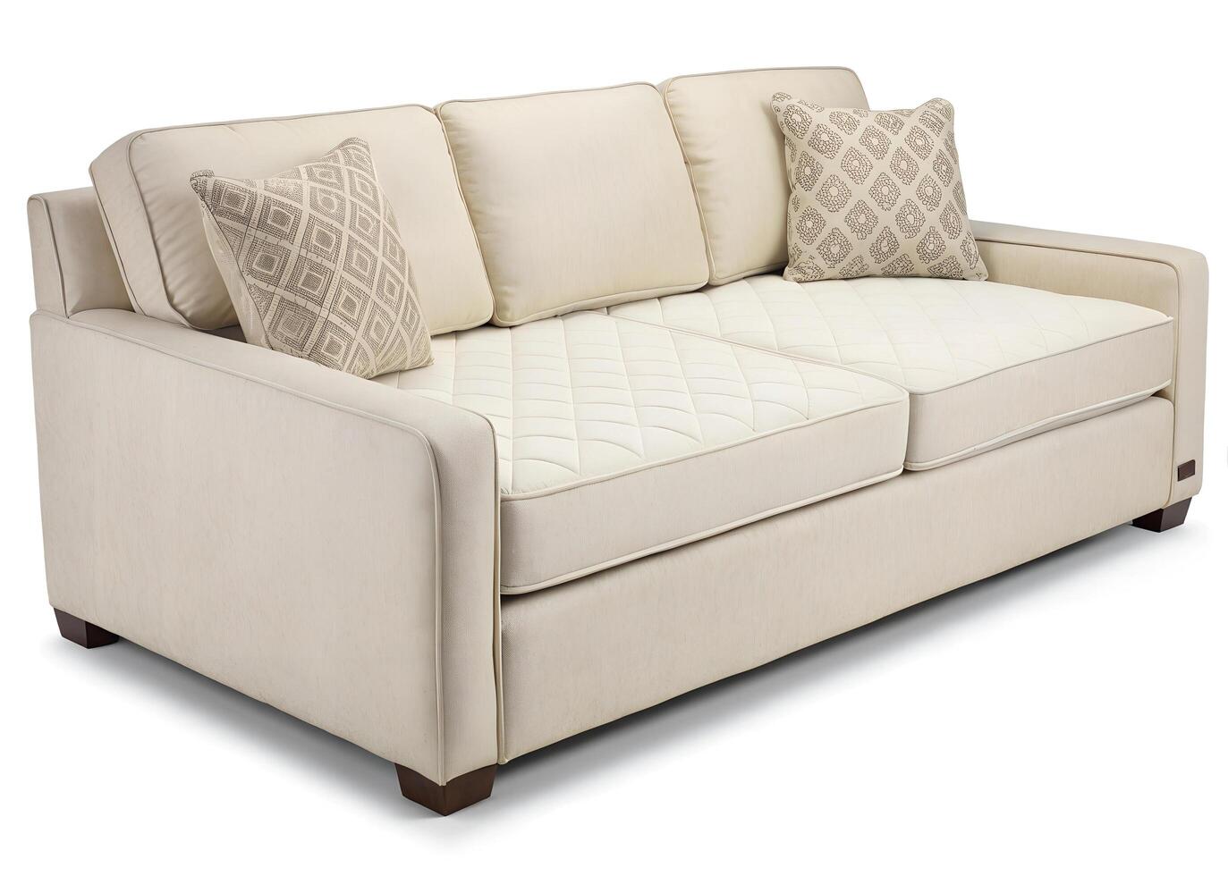 A white couch with two pillows on it photo
