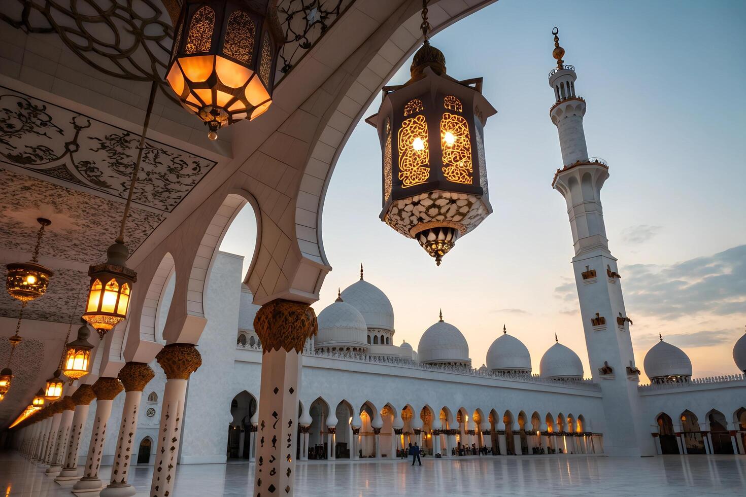 Intricately designed lanterns hang from arches in a mosque courtyard during sunset photo