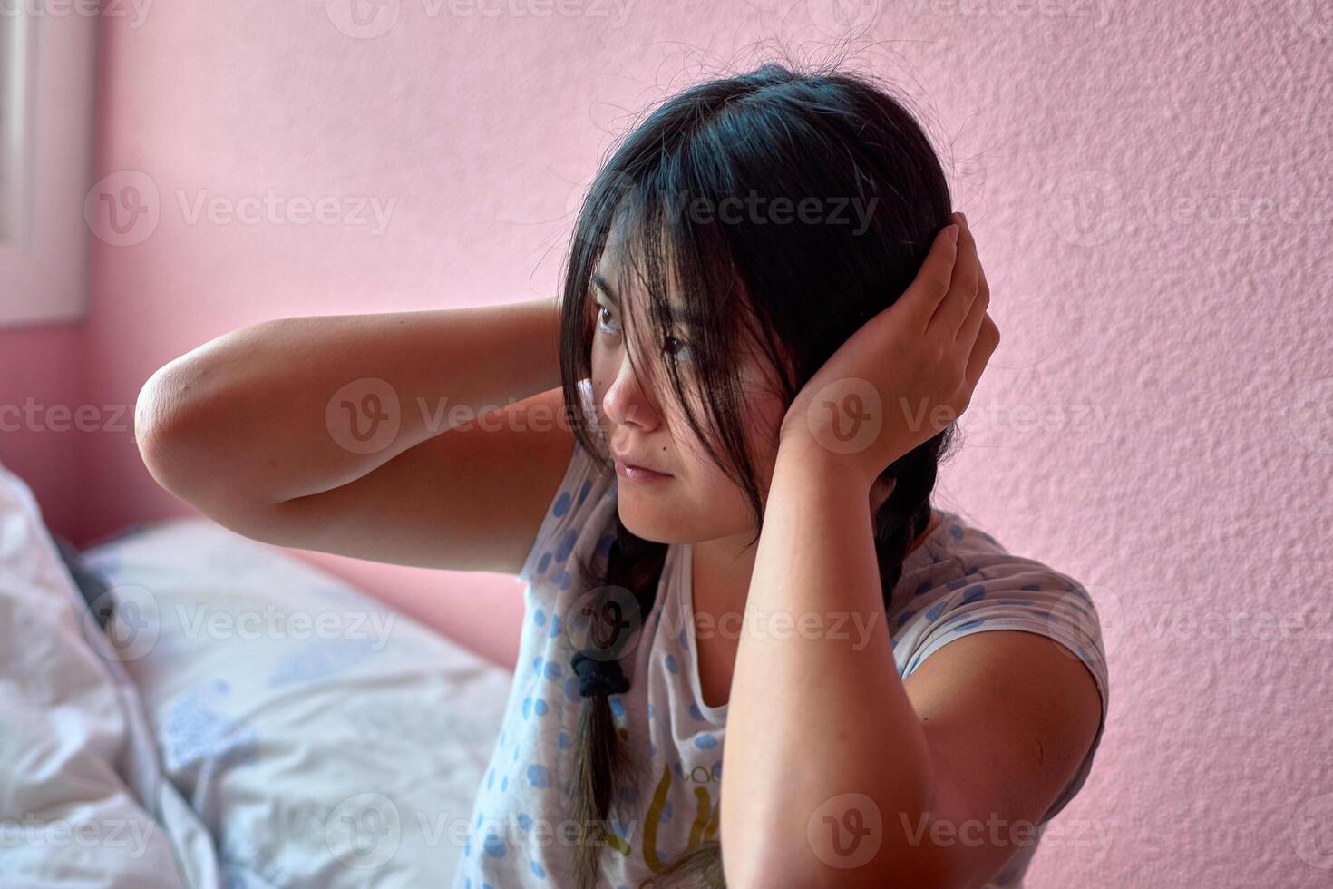 A child with pigtails faces anxiety from intolerable loud sounds photo