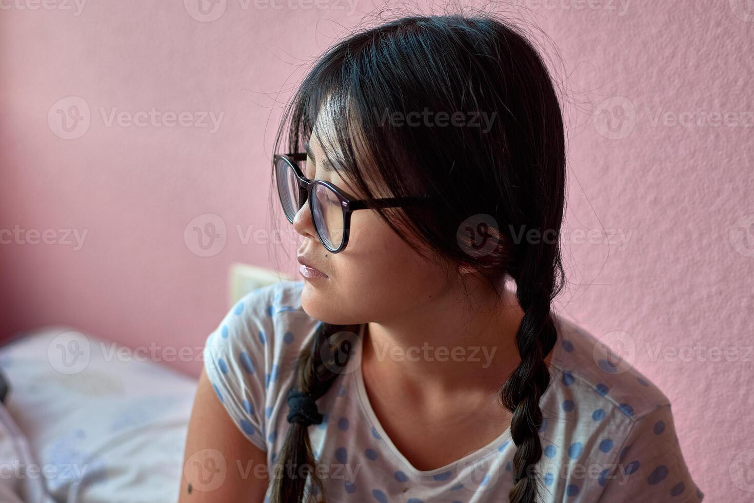 A serene moment young autistic Chinese woman in pigtails photo