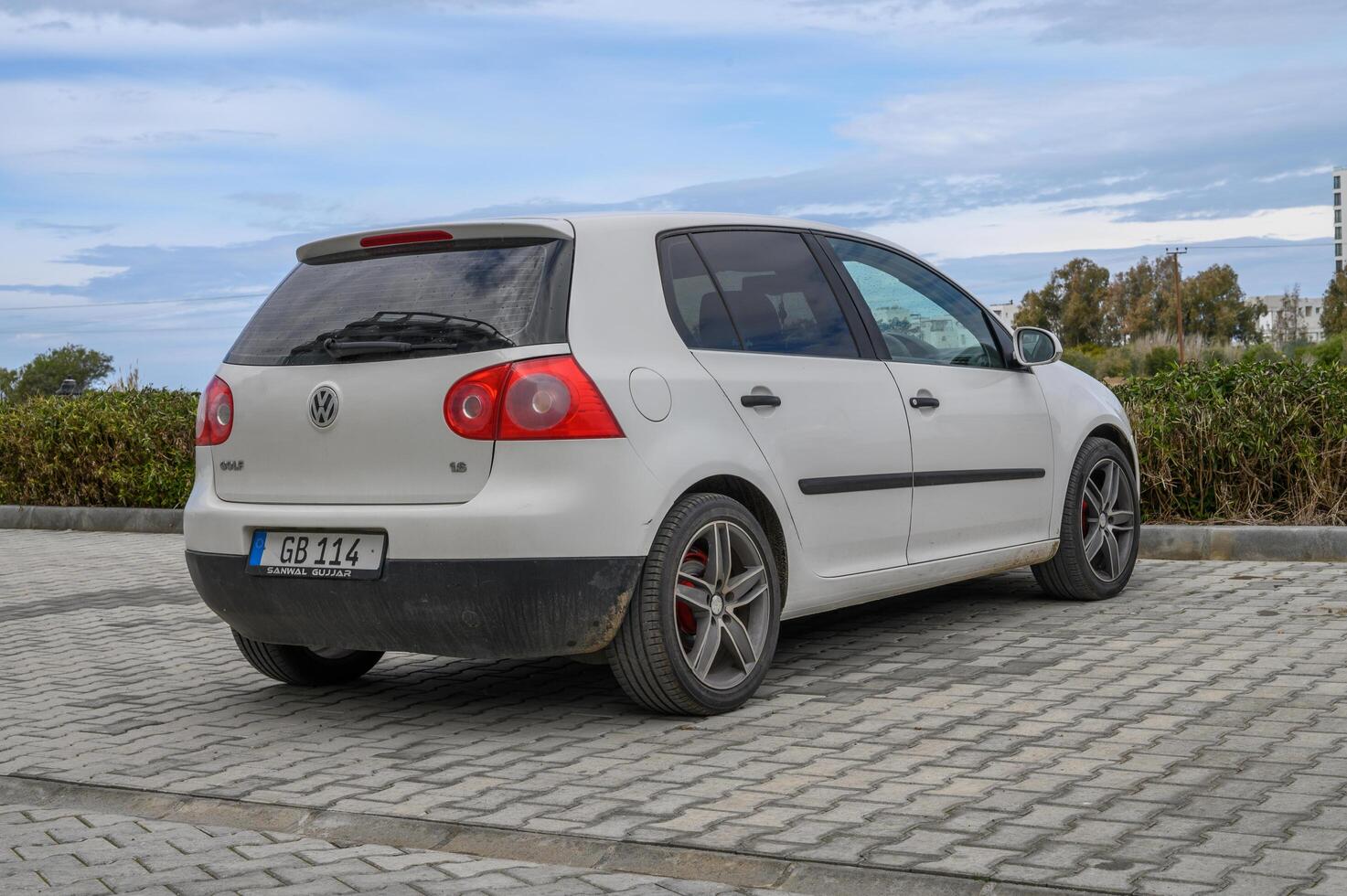 Gaziveren Cyprus -28.02.2025 Grey hatchback parked by a scenic coastal view on a cloudy afternoon photo