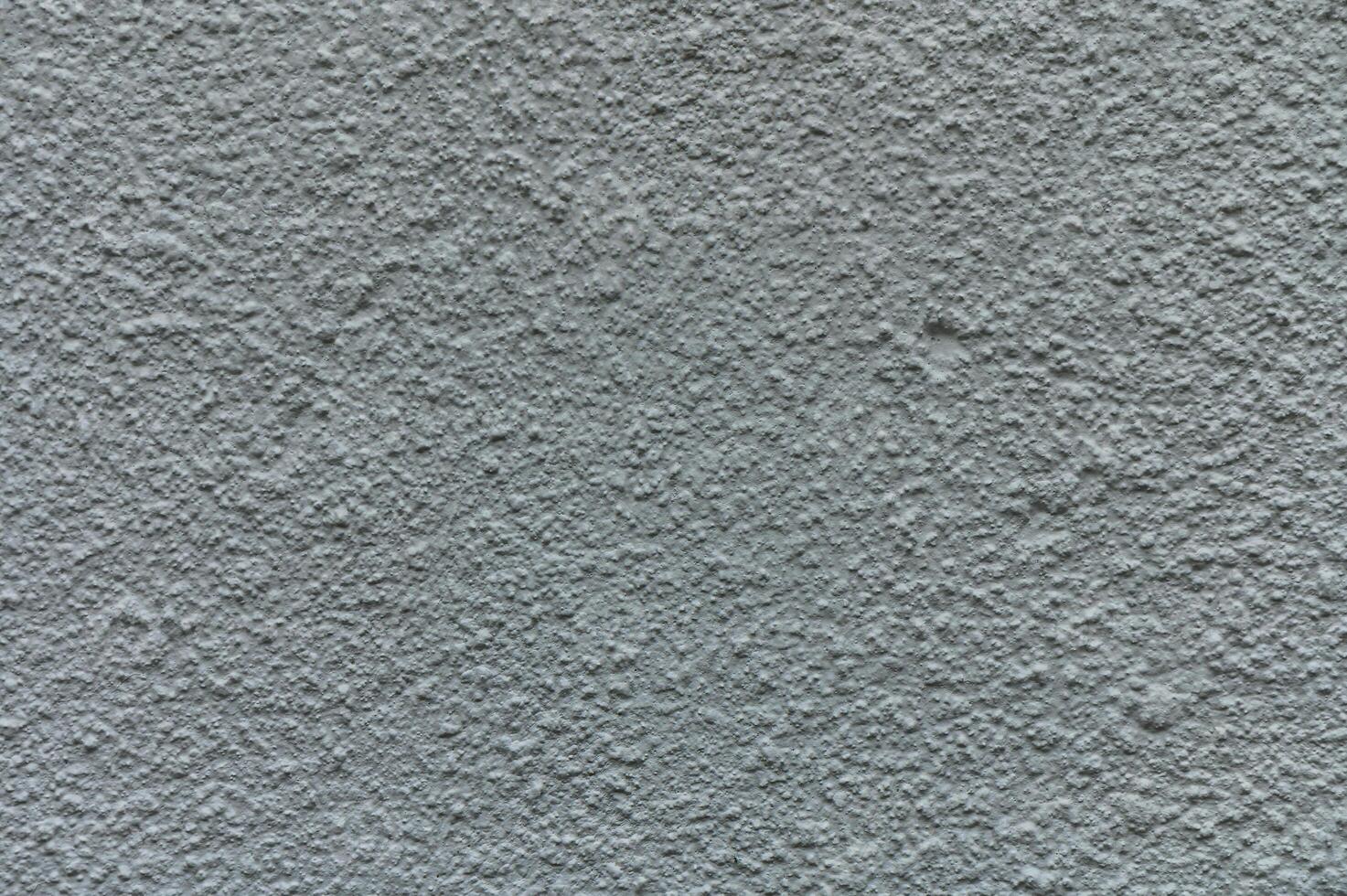 Textured wall surface showcases intricate patterns and subtle color variations in natural light photo