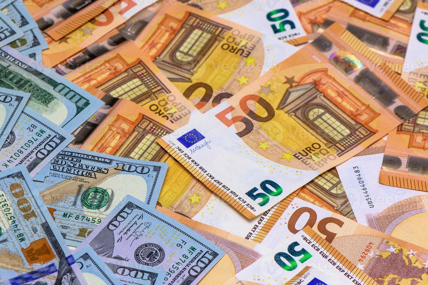 Colorful mix of European and American currency scattered on a flat surface photo