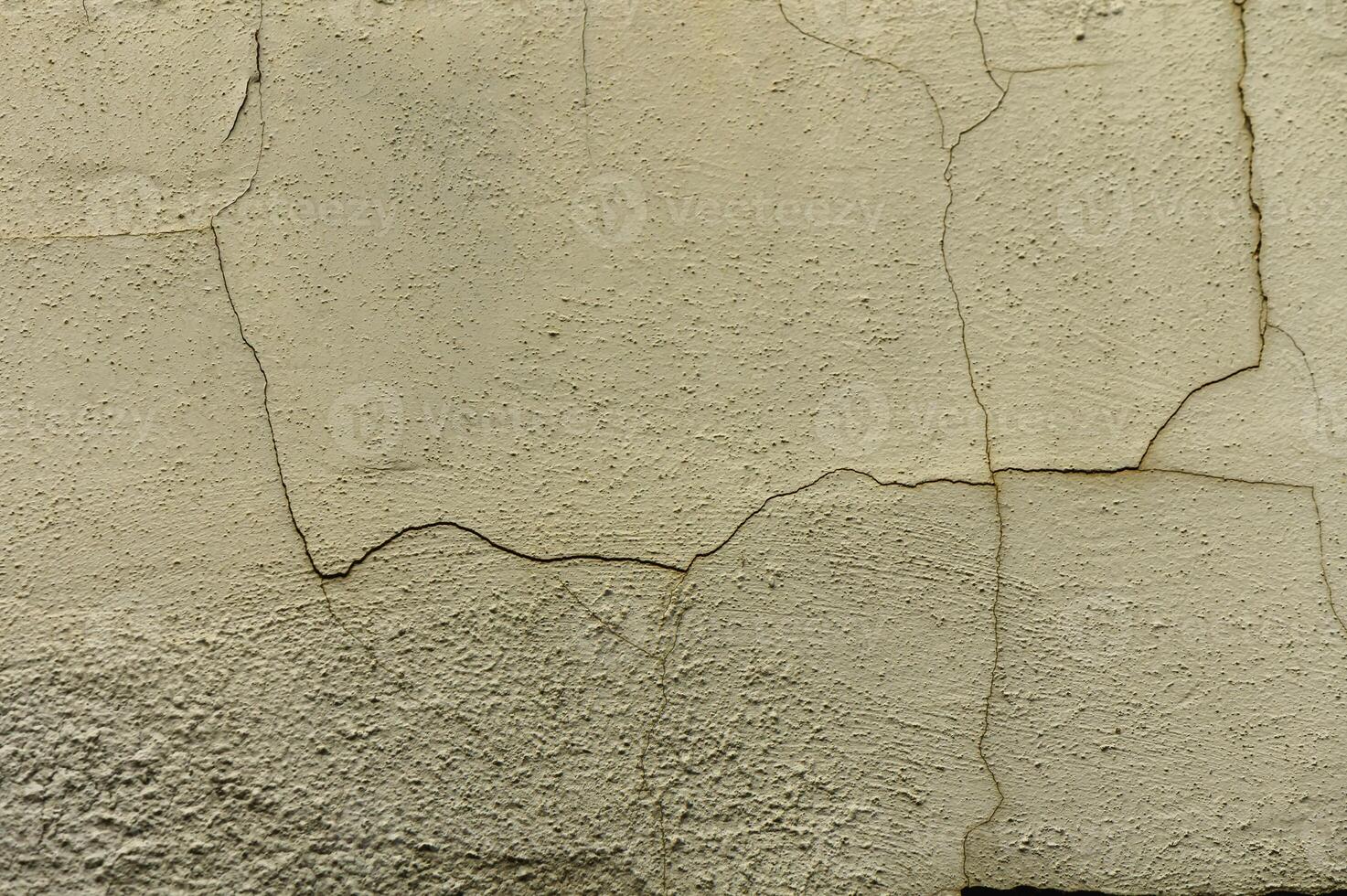 Cracked plaster revealing texture and character of aged wall in soft natural light, bringing history to life photo