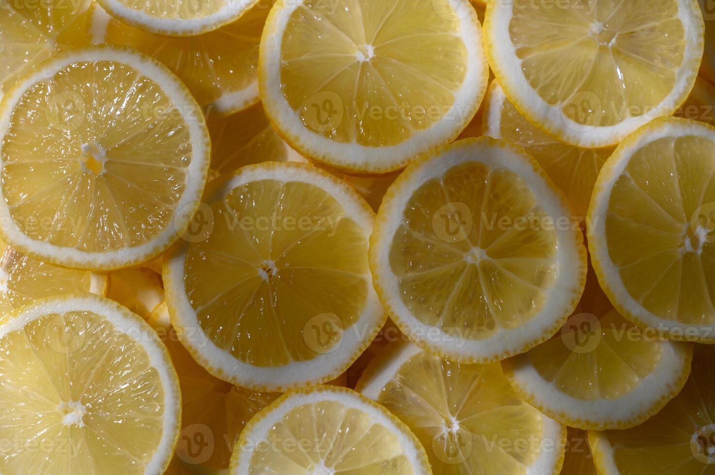 Freshly sliced lemons arranged beautifully for a vibrant culinary display in a bright kitchen photo