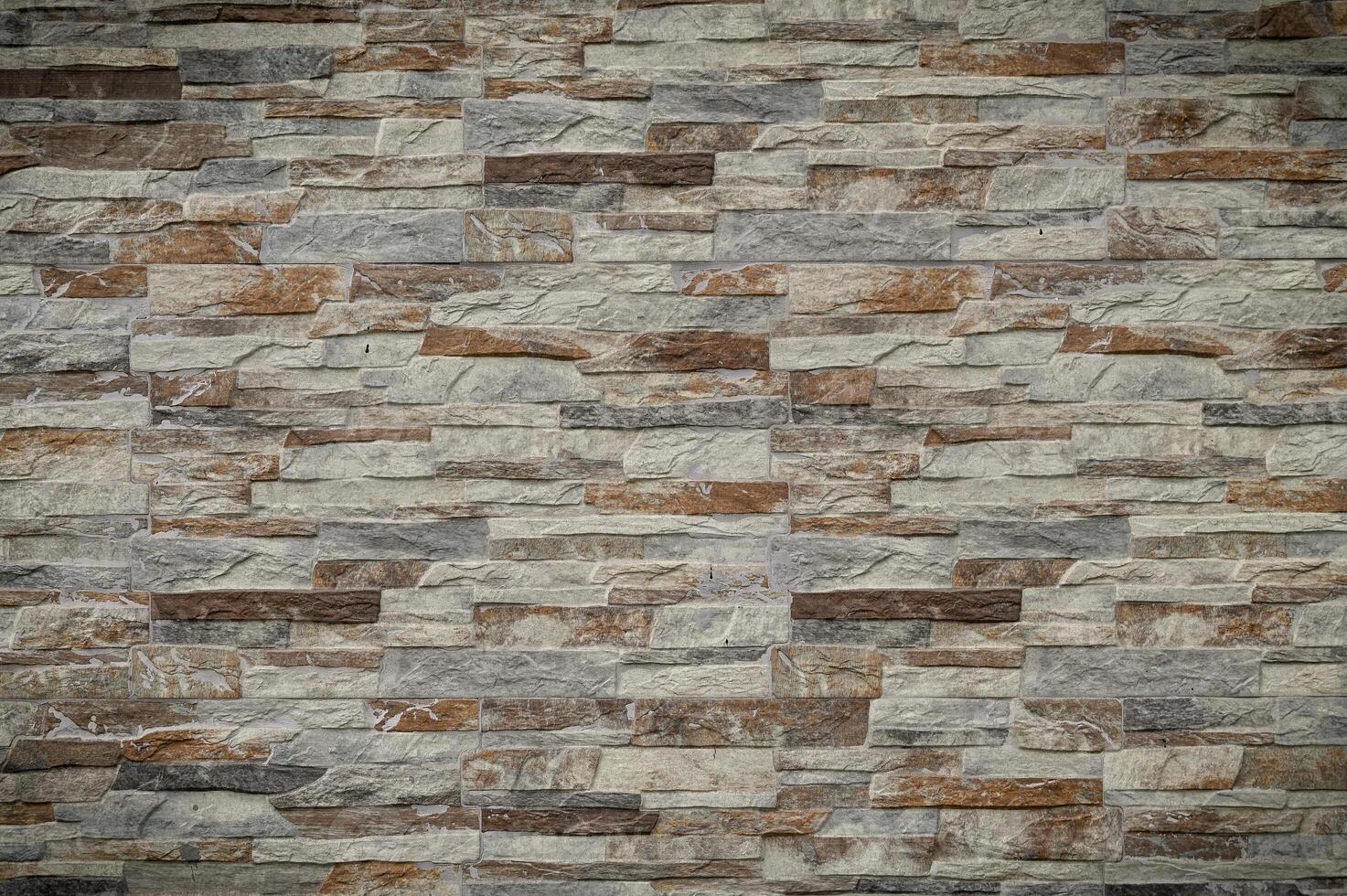 Elegantly textured stone wall showcasing earthy hues and natural patterns in serene indoor ambiance photo