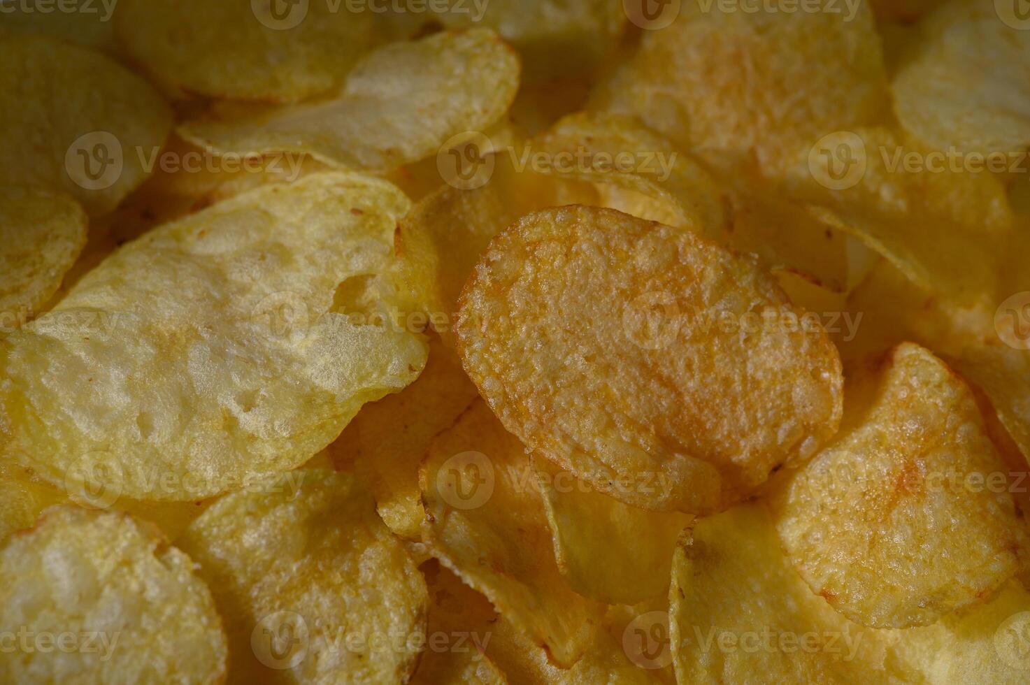 Crunchy golden potato chips arranged in a delicious, mouthwatering pattern ready for snacking photo