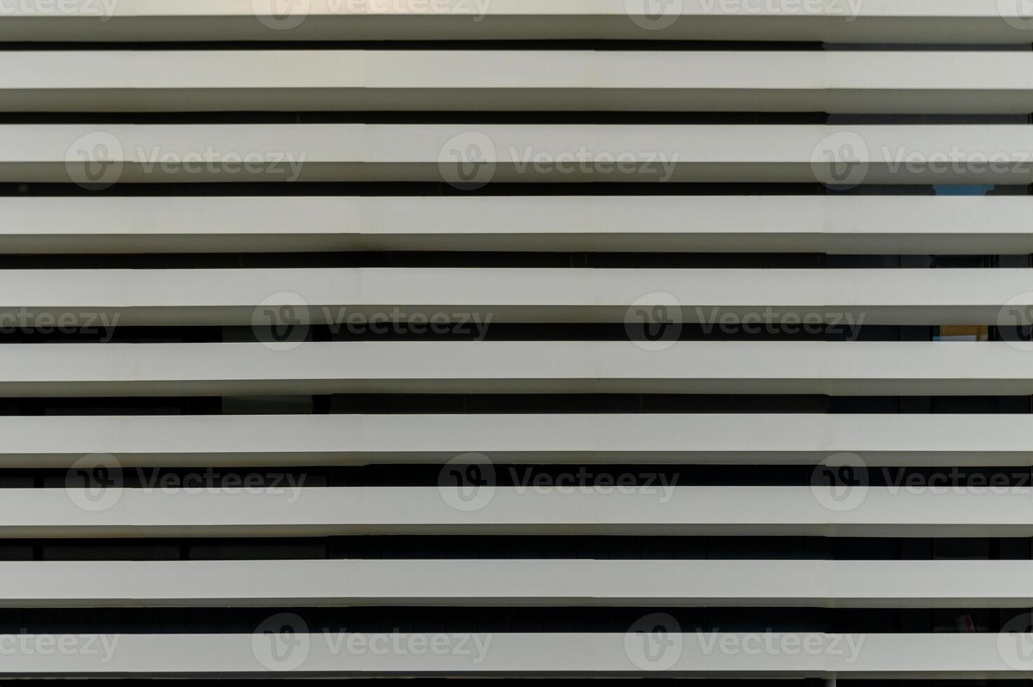 Modern architectural design showcases minimalist white horizontal slats in a contemporary building facade photo