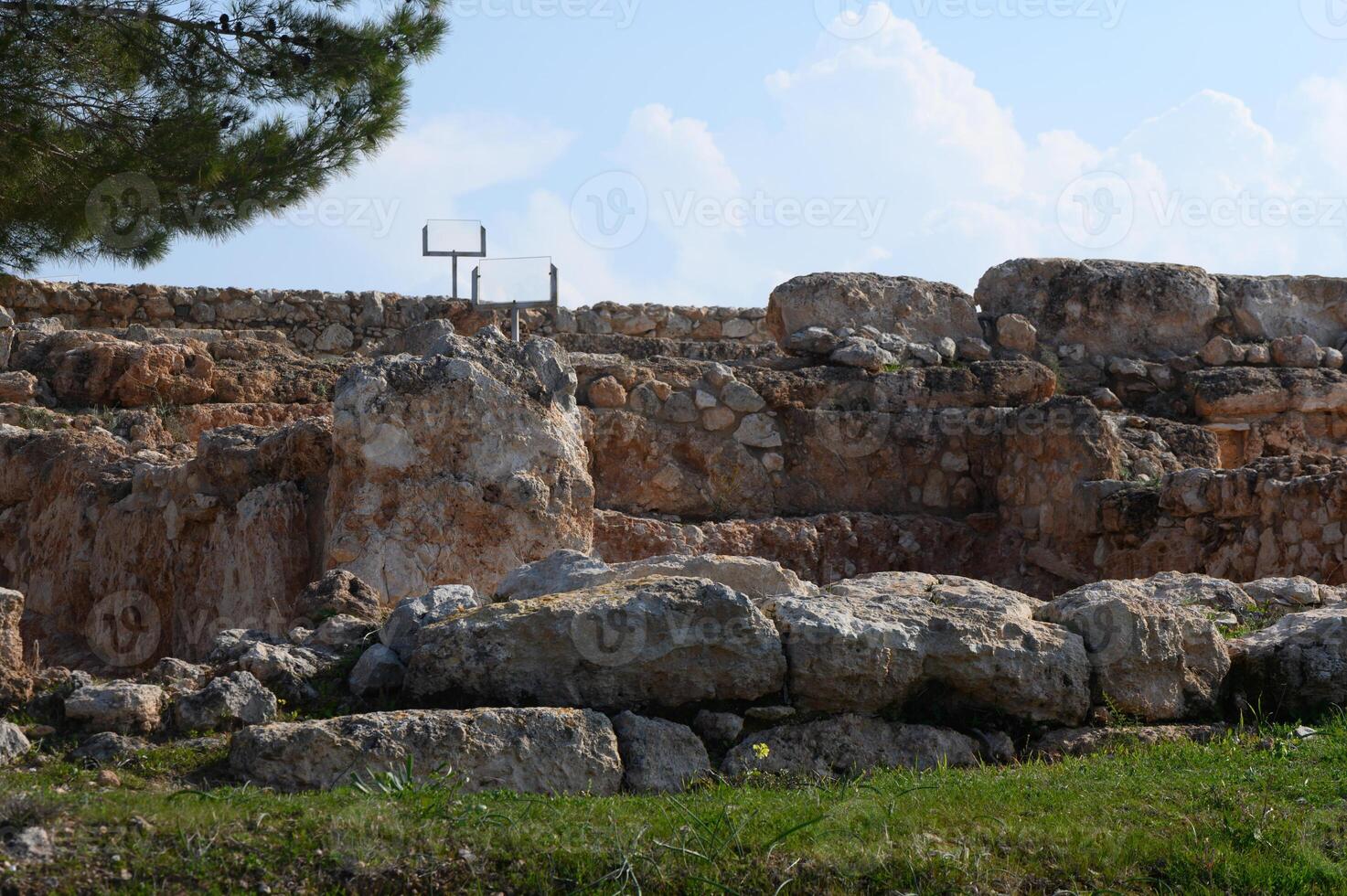 Historical ruins under a bright sky highlighting ancient stone structures and the passing of time photo