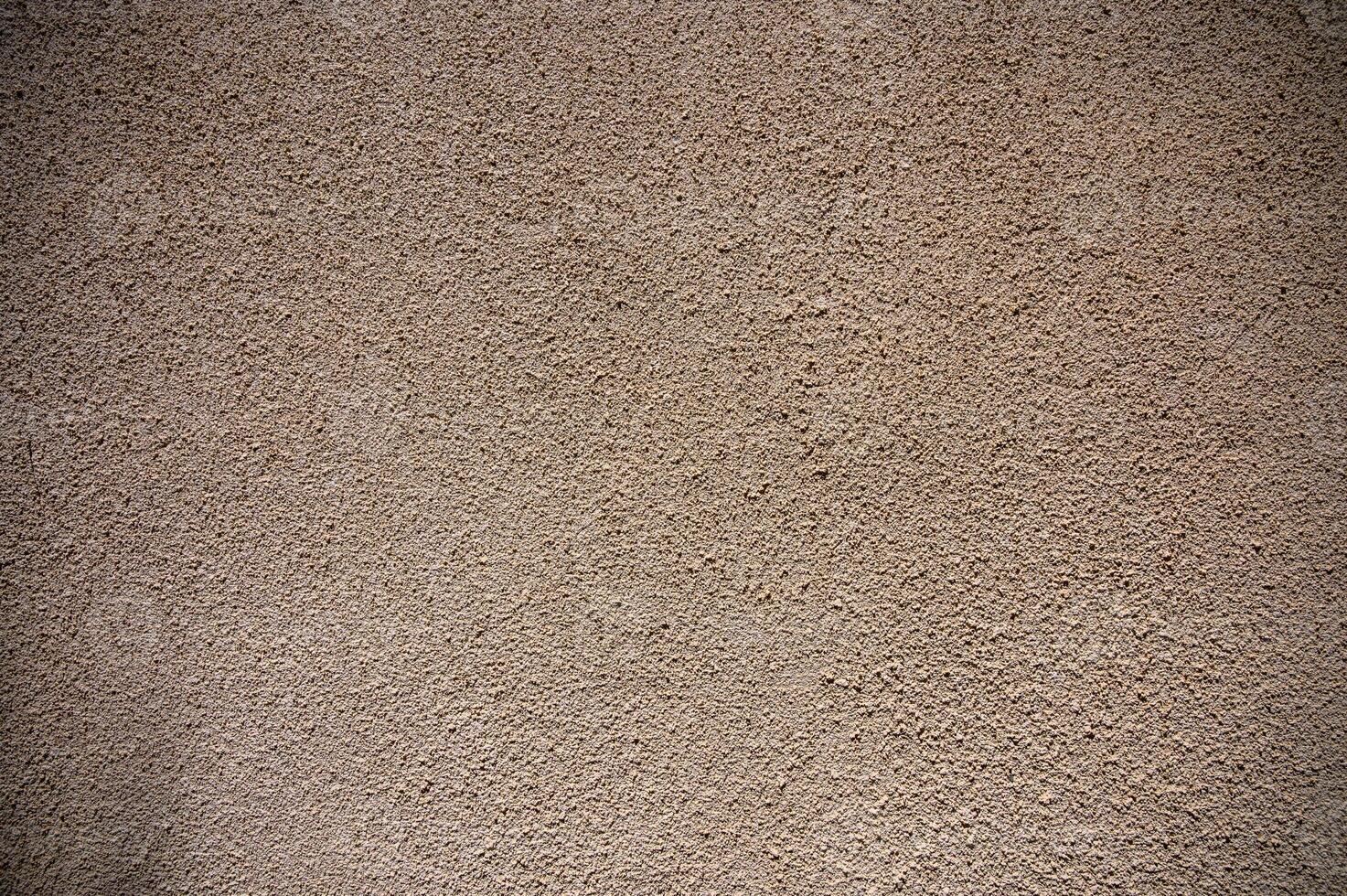 Textured plaster wall showcases nature-inspired patterns and colors in warm tones for an artistic backdrop photo