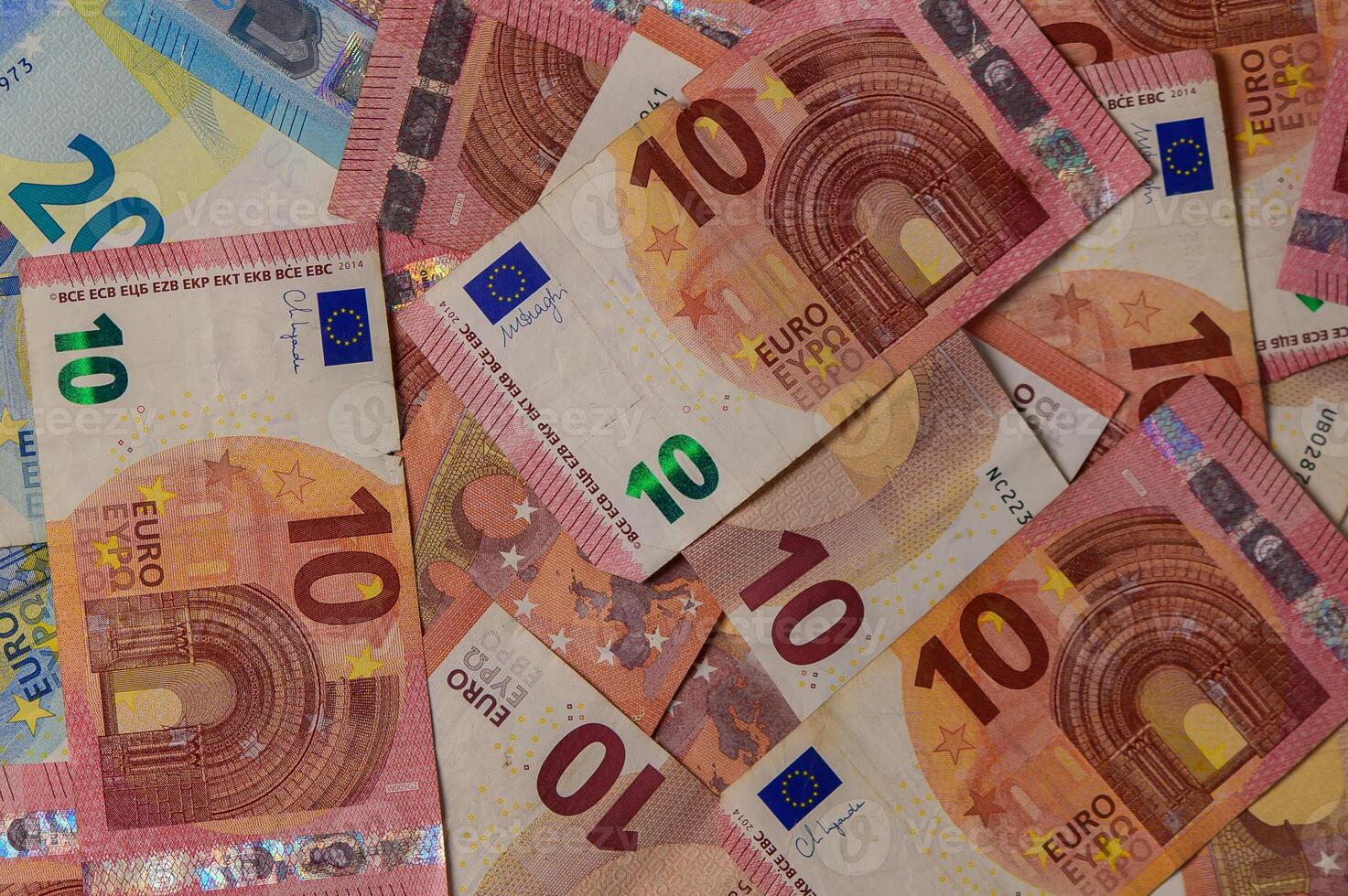Colorful collection of euro banknotes spread across a surface, showcasing intricate designs and vivid hues photo