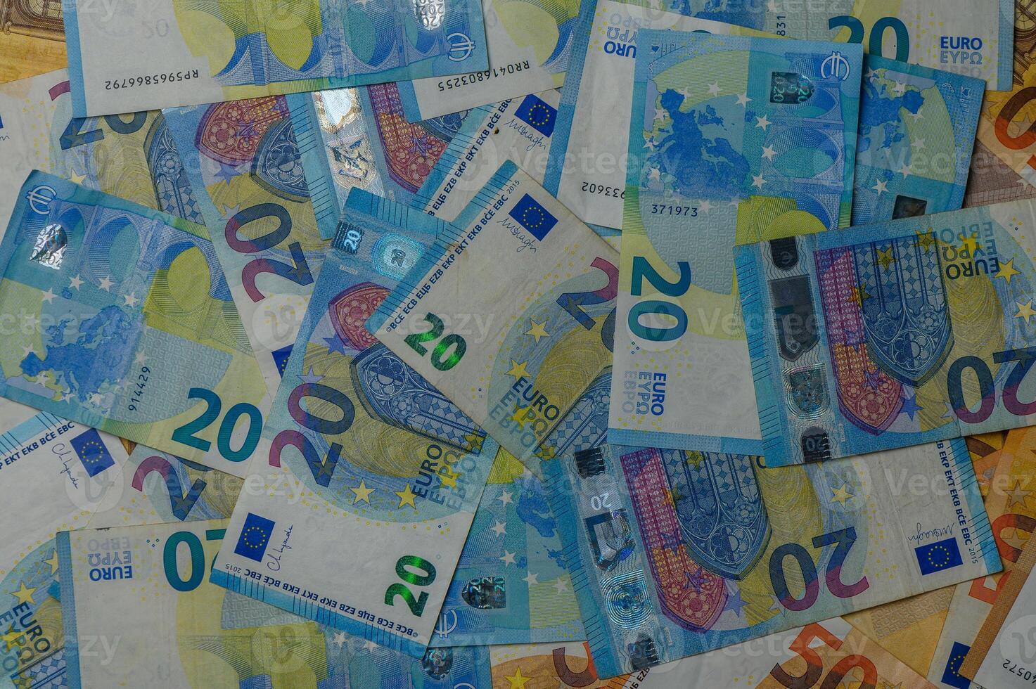 20 Euro banknotes scattered across a surface, creating a colorful and vibrant display of currency photo