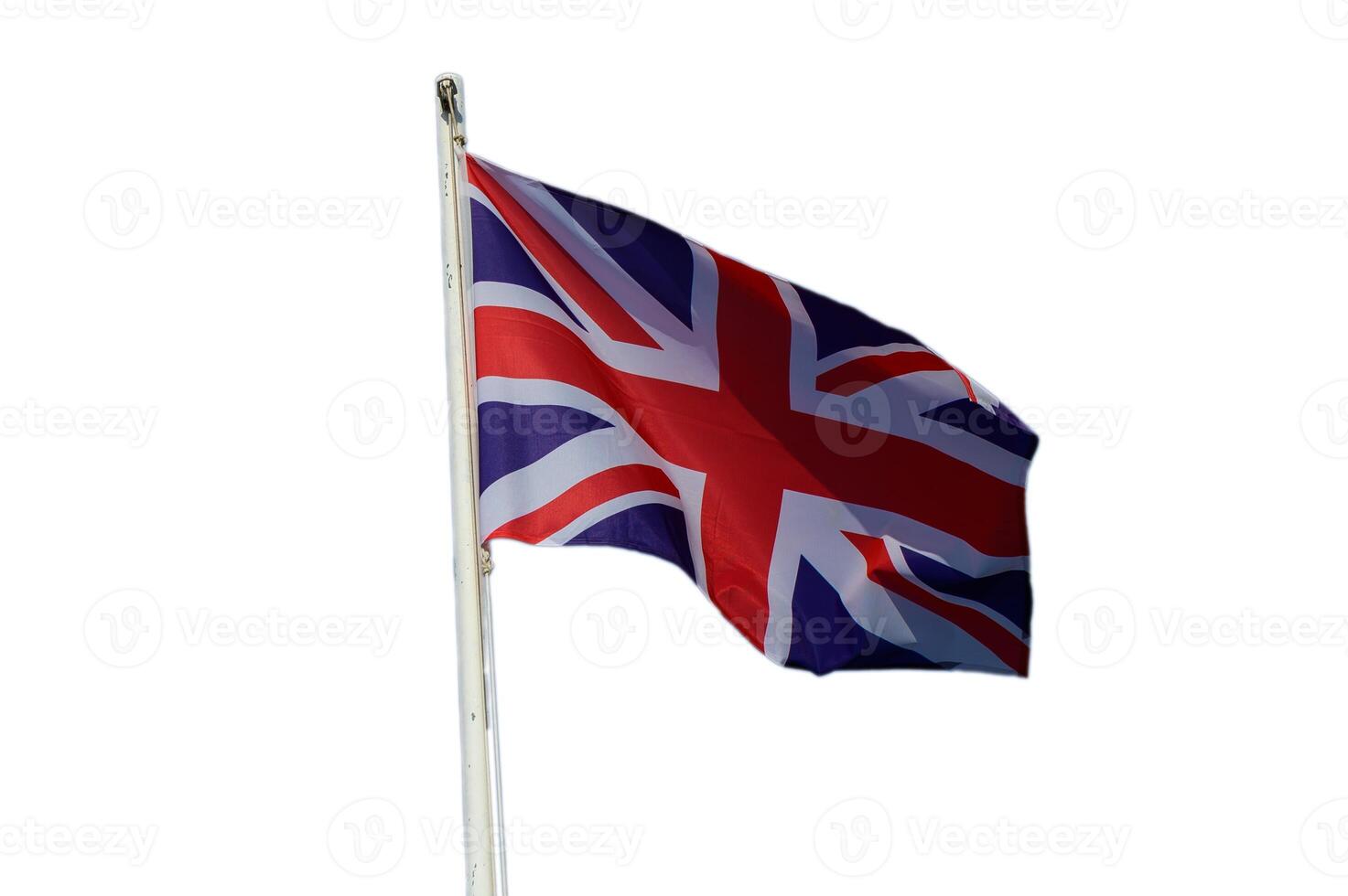 Union Jack flutters proudly in a gentle breeze under clear blue skies photo