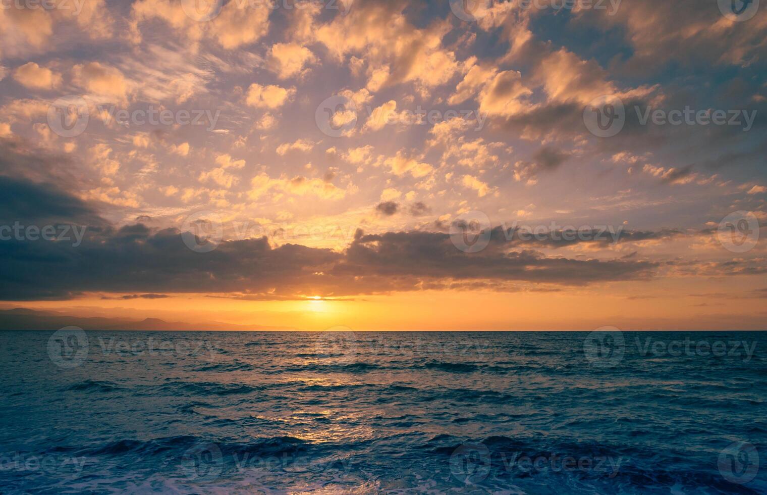 Captivating sunset paints the sky in vibrant hues over the tranquil ocean waves photo